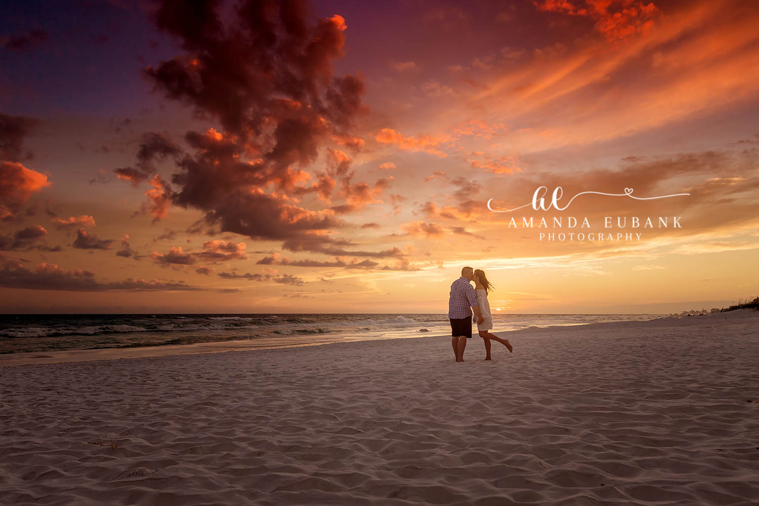 Silhouetted Kiss at Sunset | Engagement Photographer in Tampa, Florida Engagement photos in Tampa, FL showing the silhouette of a couple kissing on an empty beach under a fiery orange sky.