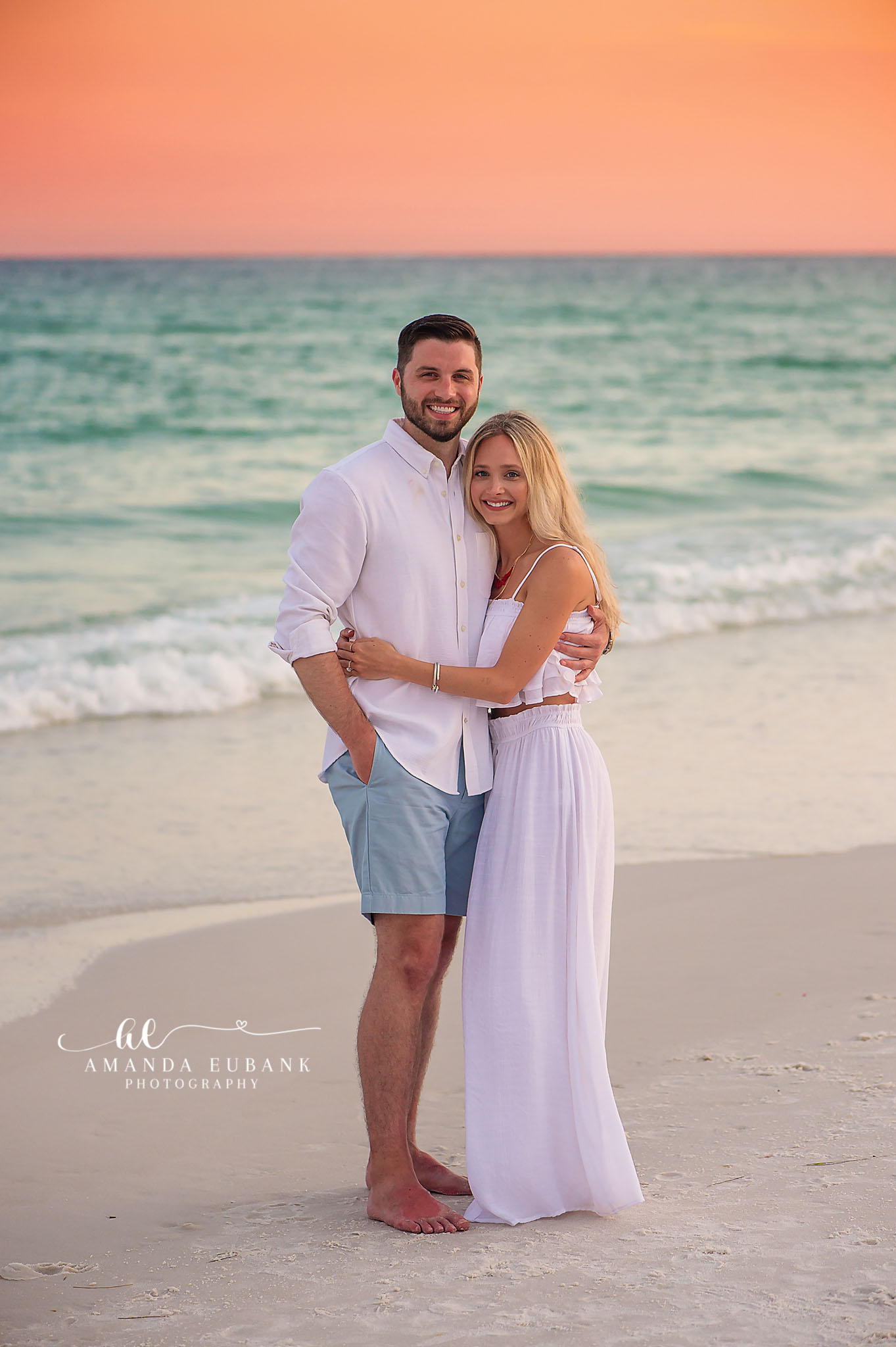 Beach Portrait in a Flowing Gown — Tampa Bay Engagement Photography A couple standing close on the shoreline with her long gown drifting in the breeze — beach engagement photography in Tampa Bay.