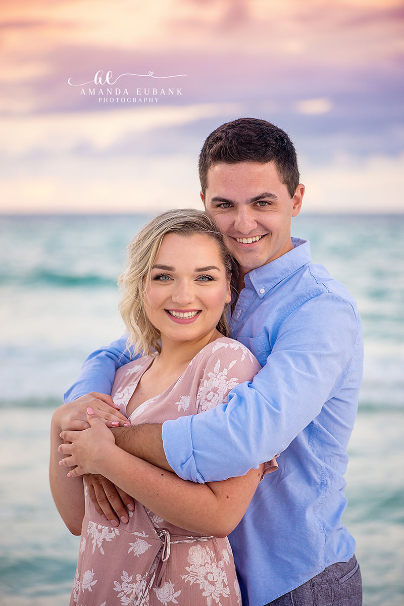Newly Engaged Portrait — Tampa Bay Engagement Photography A newly engaged couple holding each other and smiling toward the camera at dusk — beach engagement photography in Tampa Bay.