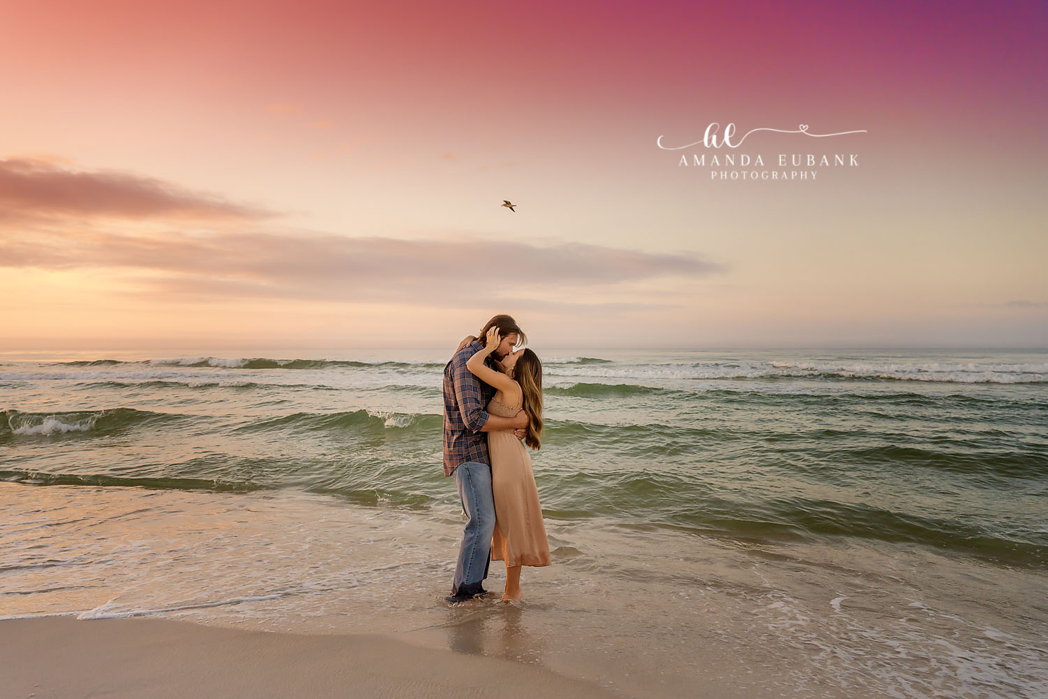 Ankle-Deep in the Gulf | Tampa Engagement Photographer A couple holding each other ankle-deep in the surf in muted sunset light during a Tampa engagement photography session.