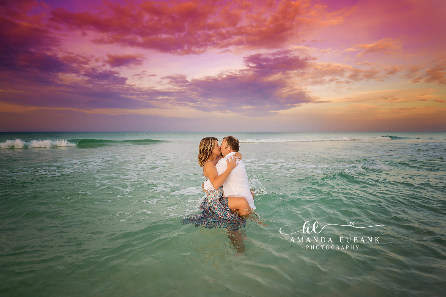 Kissing in the Gulf — Tampa, FL Engagement Session A couple kissing waist-deep in the Gulf with her sequined gown floating on the water at a Gulf beach engagement session near Tampa, Florida.