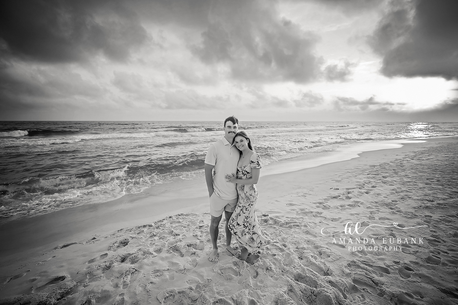 Black and White Beach Portrait | Tampa Beach Engagement Photography Tampa engagement photographer captures a black and white portrait of a couple holding each other on a windswept beach.
