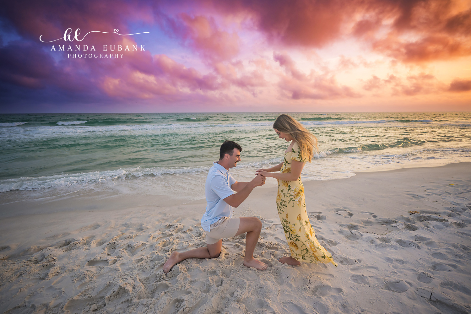 Slipping On the Ring | Tampa Beach Engagement Photography Tampa engagement photographer captures the moment the ring slides onto her finger beside the breaking surf.