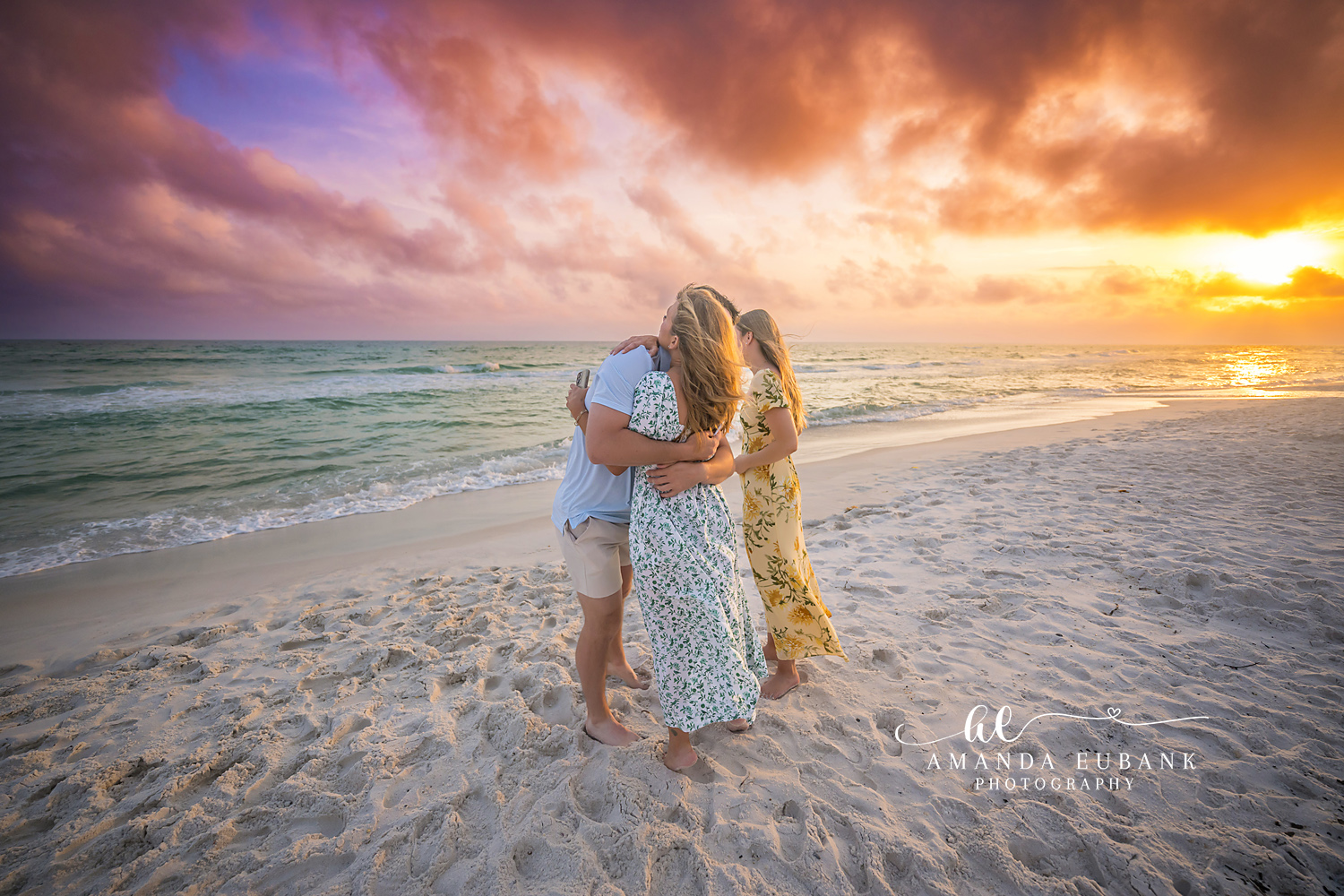 Golden Light Embrace | Tampa Beach Engagement Photography Tampa engagement photographer captures a couple wrapped together as the sun sits low and gold on the water.