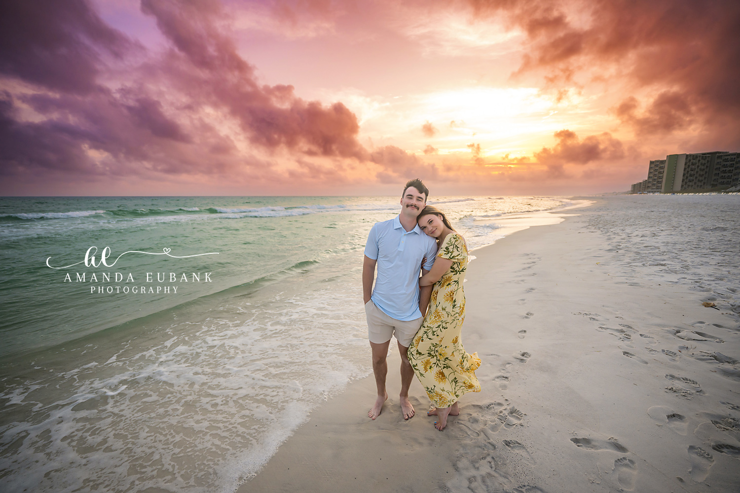 Sun Flare on the Beach | Tampa Engagement Photographer A couple standing together on the sand as the sun flares over the turquoise Gulf during a Tampa engagement photography session.