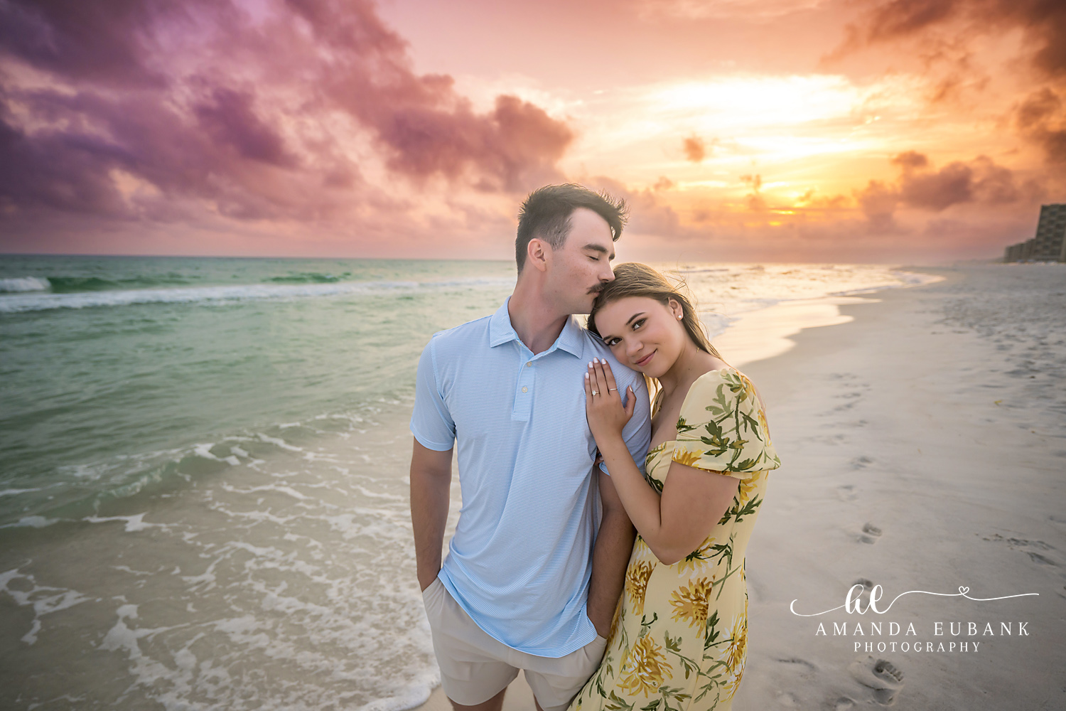 Forehead Kiss at Sunset | Tampa Beach Engagement Photography Tampa engagement photographer captures a man kissing his fiancee's forehead as she rests against his chest at sunset.