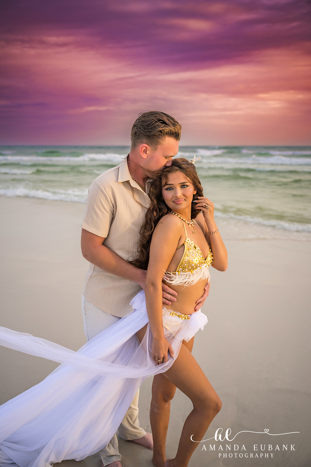 Temple Kiss at Sunset | Tampa Beach Engagement Photography Tampa engagement photographer captures a man kissing her temple as her gold gown and white overlay catch the light.