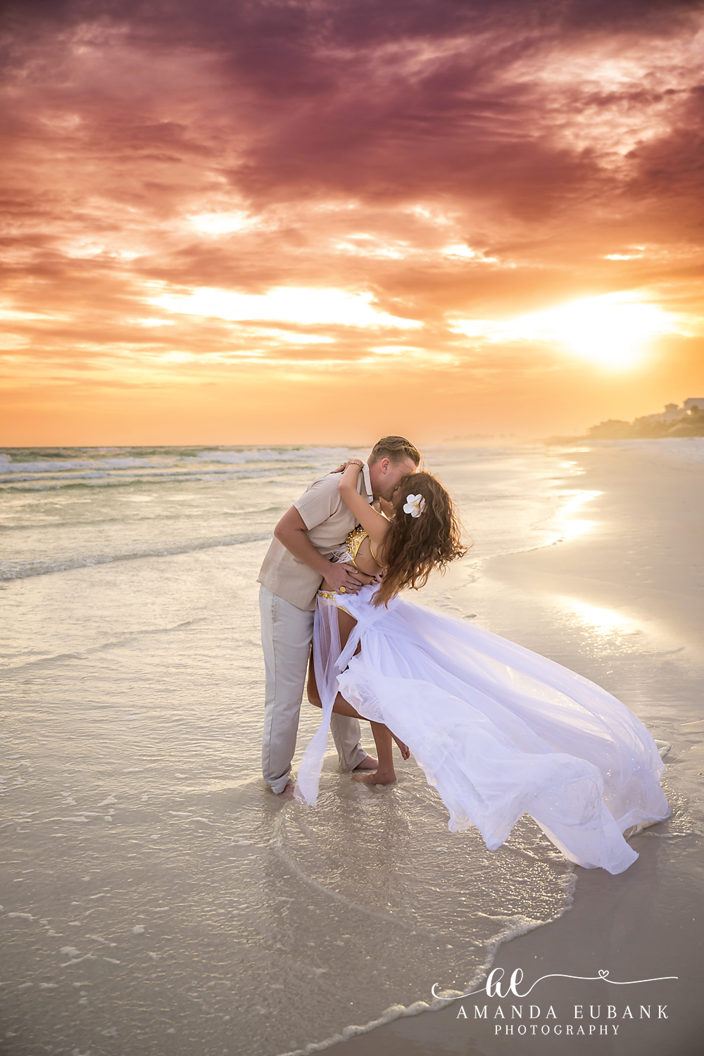 Silhouette Dip at Sundown — Tampa Bay Engagement Photography The silhouette of a dip kiss against the setting sun with her gown flowing — beach engagement photography in Tampa Bay.
