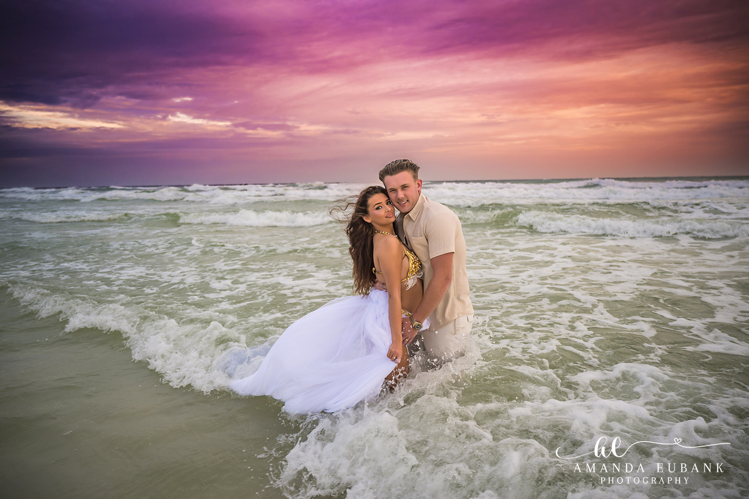 Laughing in the Gulf — Tampa Bay Engagement Photography A couple laughing together in the surf as her gown swirls at dusk — beach engagement photography in Tampa Bay.