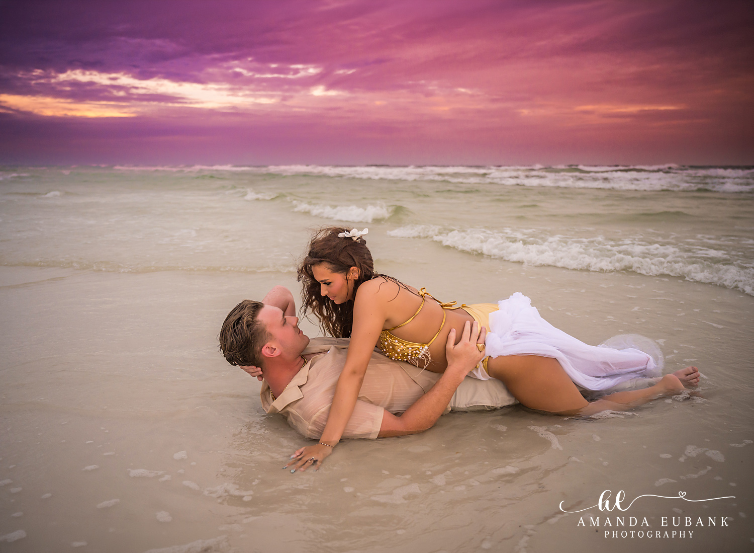 Together in the Shallows | Tampa Beach Engagement Photography Tampa engagement photographer captures a couple lying together in the warm shallows beneath a purple sky.