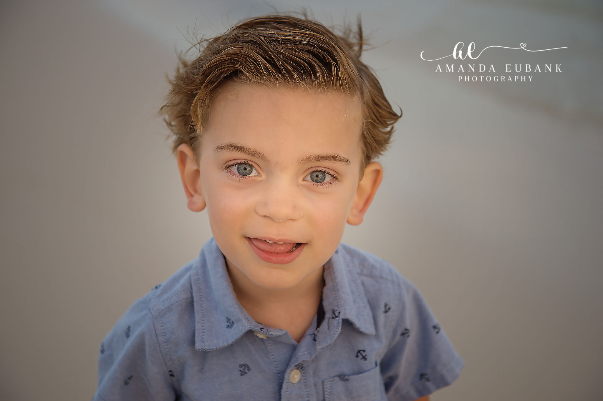 Close-Up Child Portrait | Tampa Children’s Photographer A close-up portrait of a young boy in a chambray shirt against a soft backdrop during a children’s portrait session in Tampa, Florida.