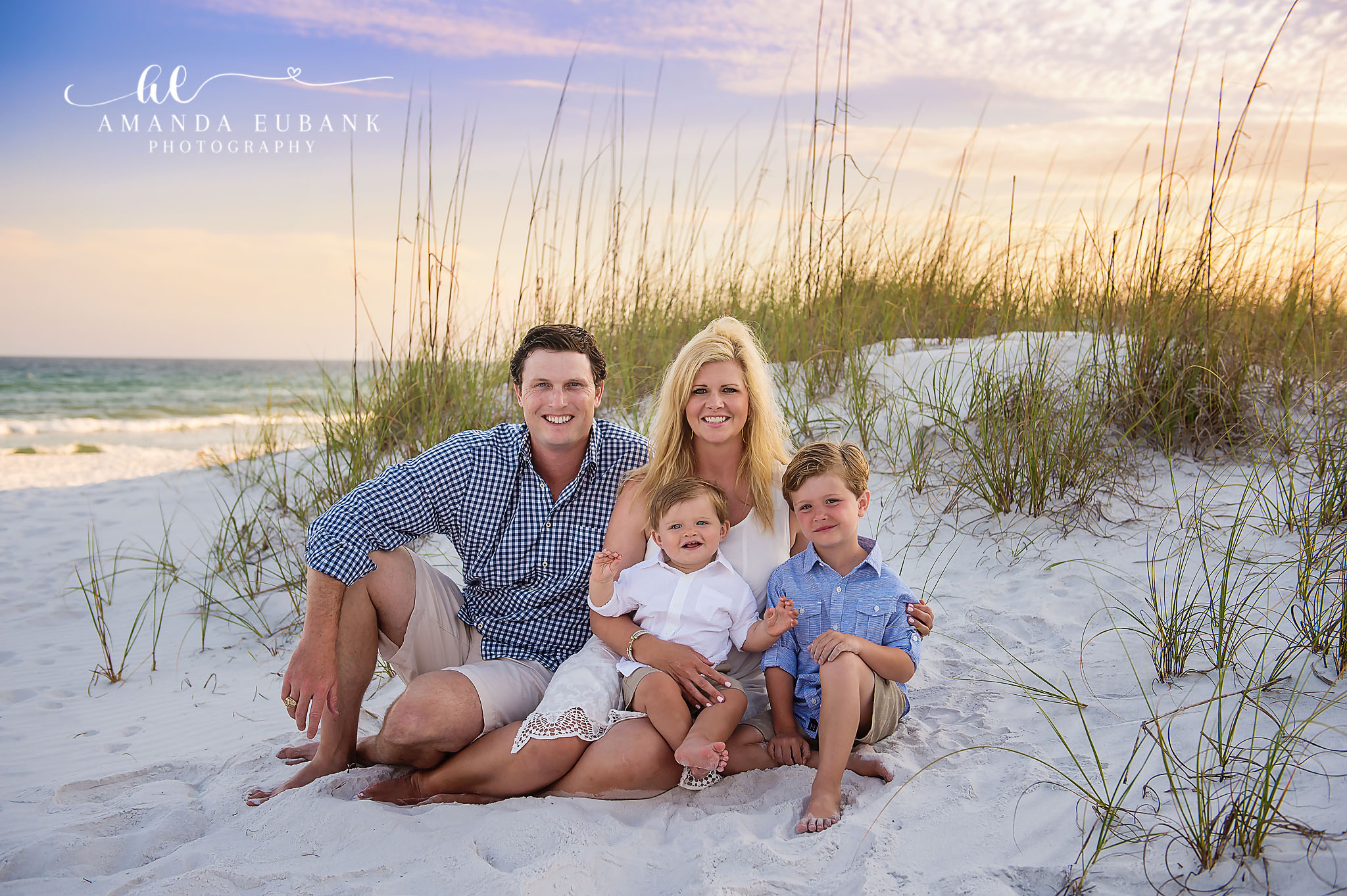 Family of Five in the Dunes | Tampa Family Photographer A family of five sitting together on the sand at the base of a dune during a Tampa family photography session.