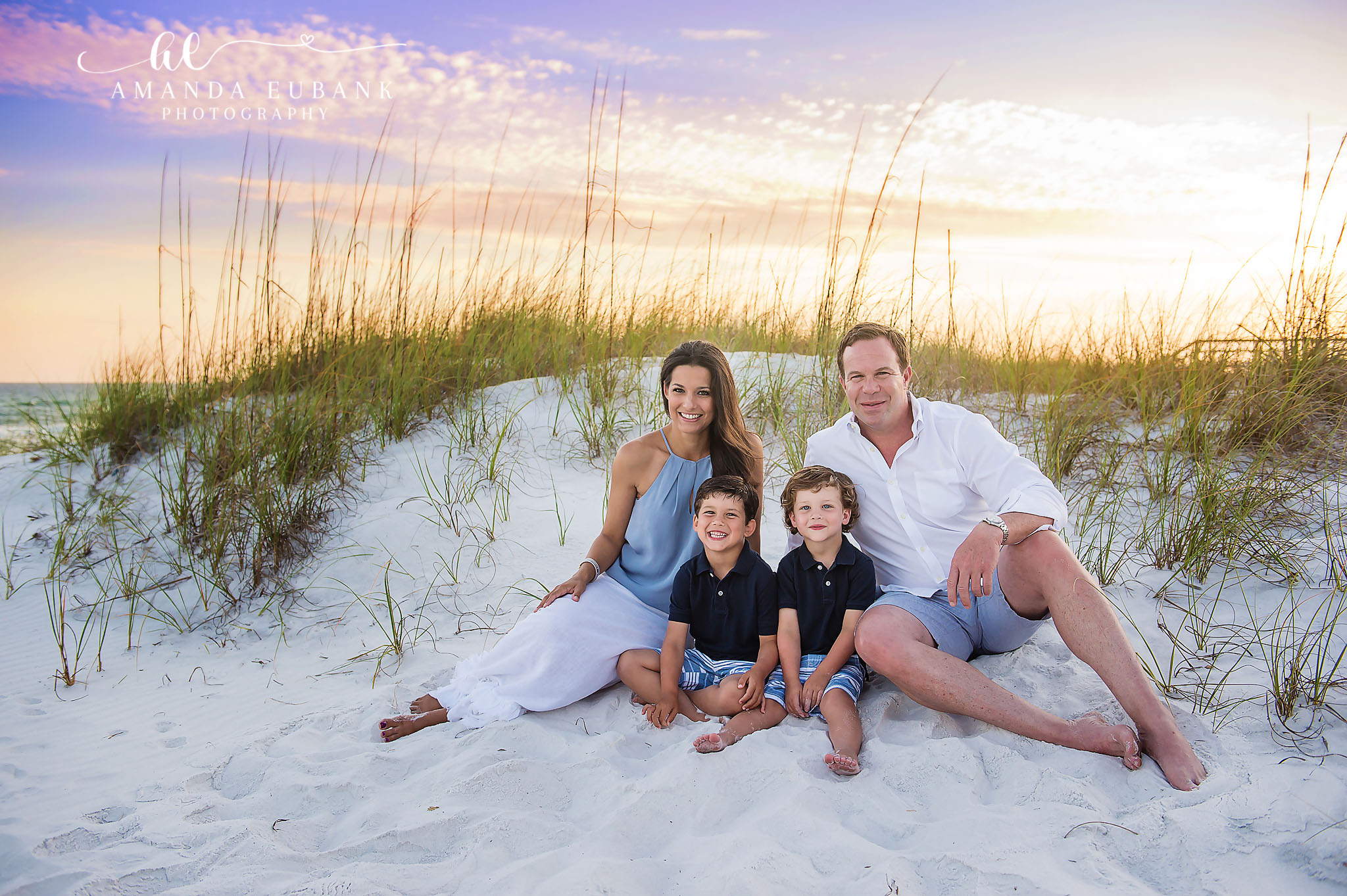 Family Portrait in the Sea Oats — Tampa, FL Family Session A family of five seated on a dune surrounded by sea oats at sunset at a beach family session near Tampa, Florida.