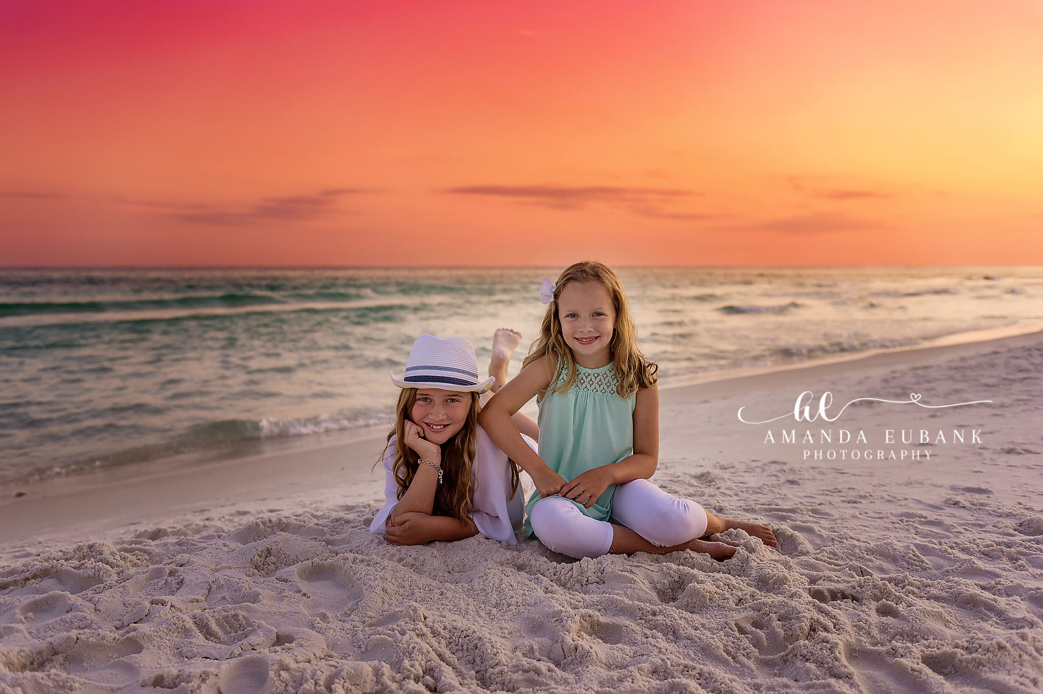 Sisters in Sun Hats — Tampa Bay Children’s Photography Two young girls in sun hats sitting on the sand as the sun drops low at a beach kids session in Tampa, FL.