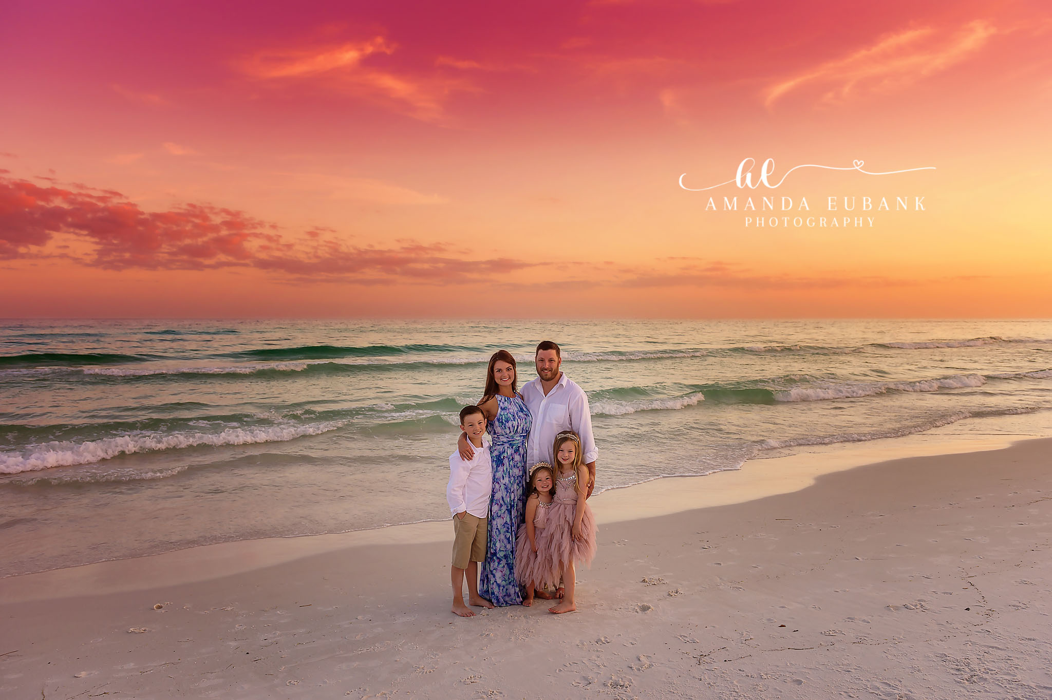 Family of Five on the Beach | Tampa Beach Family Photography Tampa family photographer captures a family of five standing on the sand in blue and blush under a coral sky.