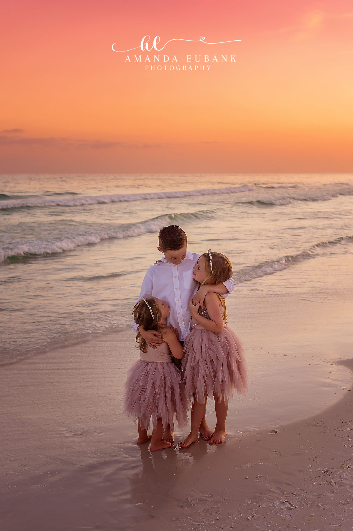 Walking Toward the Water — Tampa Bay Family Portraits A family walking toward the water together, seen from behind, at golden hour — beach family photography in Tampa Bay.