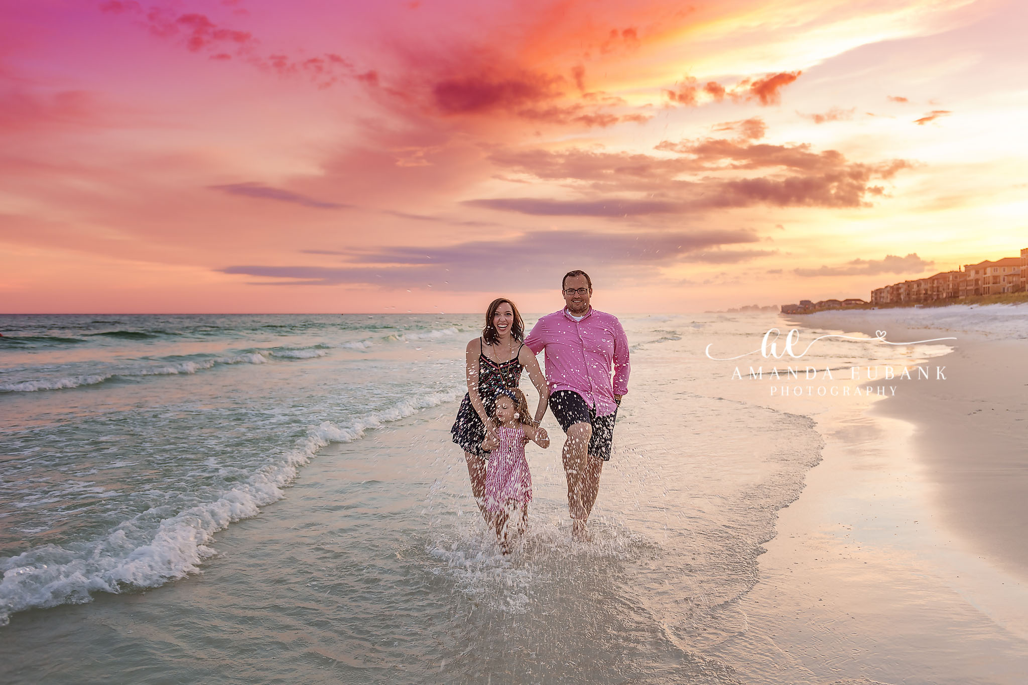 Walking Through the Surf — Tampa Bay Couples Portraits A couple walking hand in hand through the surf as the sky glows at sunset — beach couples photography in Tampa Bay.