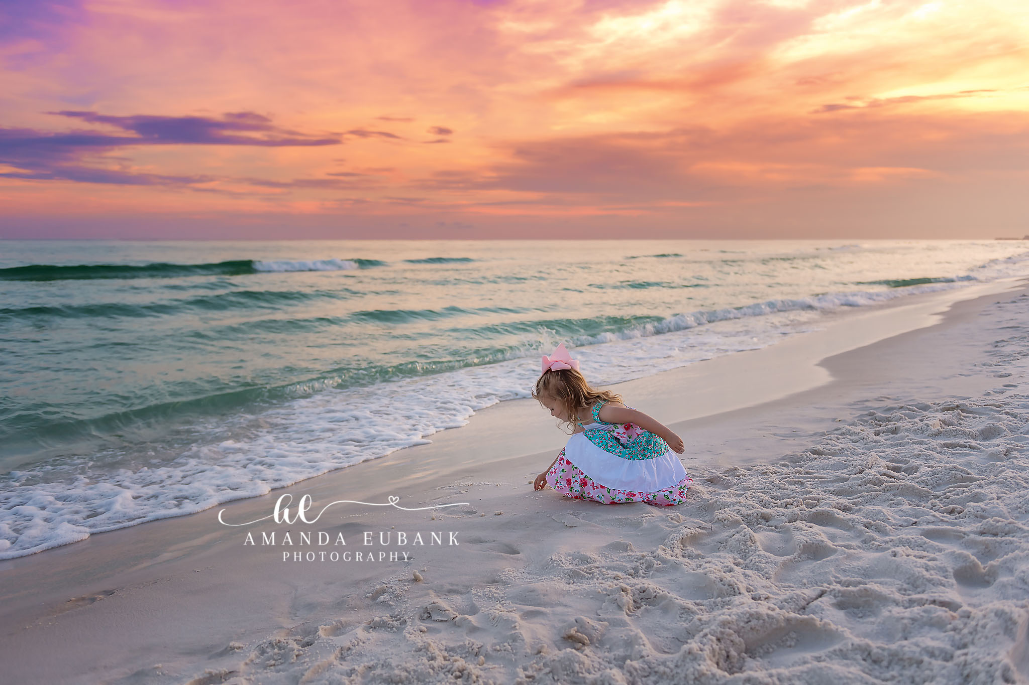 Toddler Playing in the Sand | Tampa Children’s Photographer A toddler in tulle sitting on the sand playing beside the turquoise water during a children’s portrait session in Tampa, Florida.