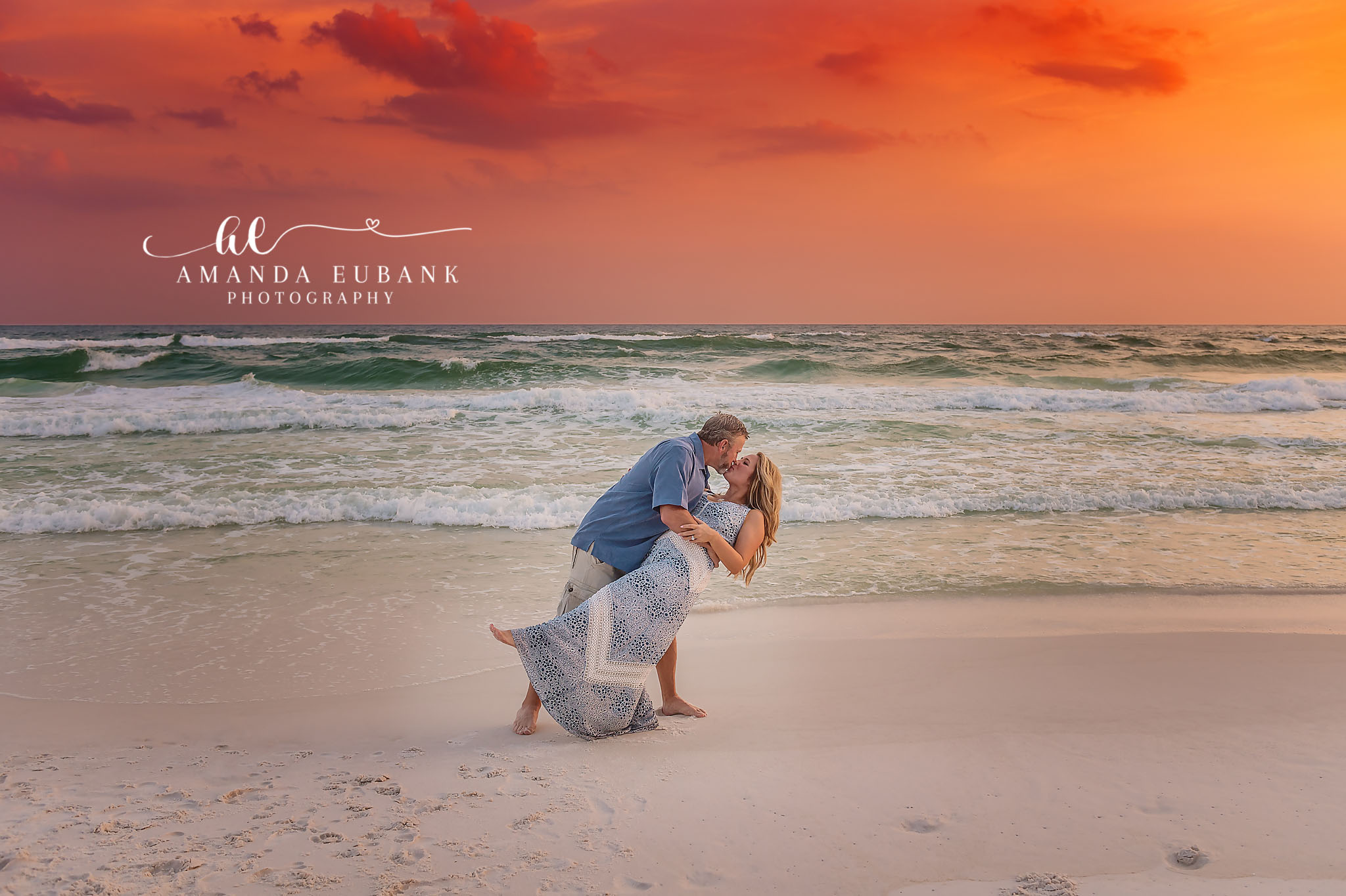 Parents Kiss on the Beach — Tampa Bay Family Portraits A dad dipping mom for a kiss on the beach while the kids play nearby — beach family photography in Tampa Bay.