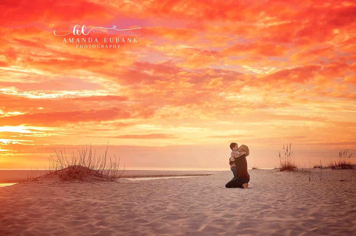 Silhouette in the Dunes | Tampa Beach Family Photography Tampa family photographer captures a mother and child silhouetted in the dunes as the sky burns orange.