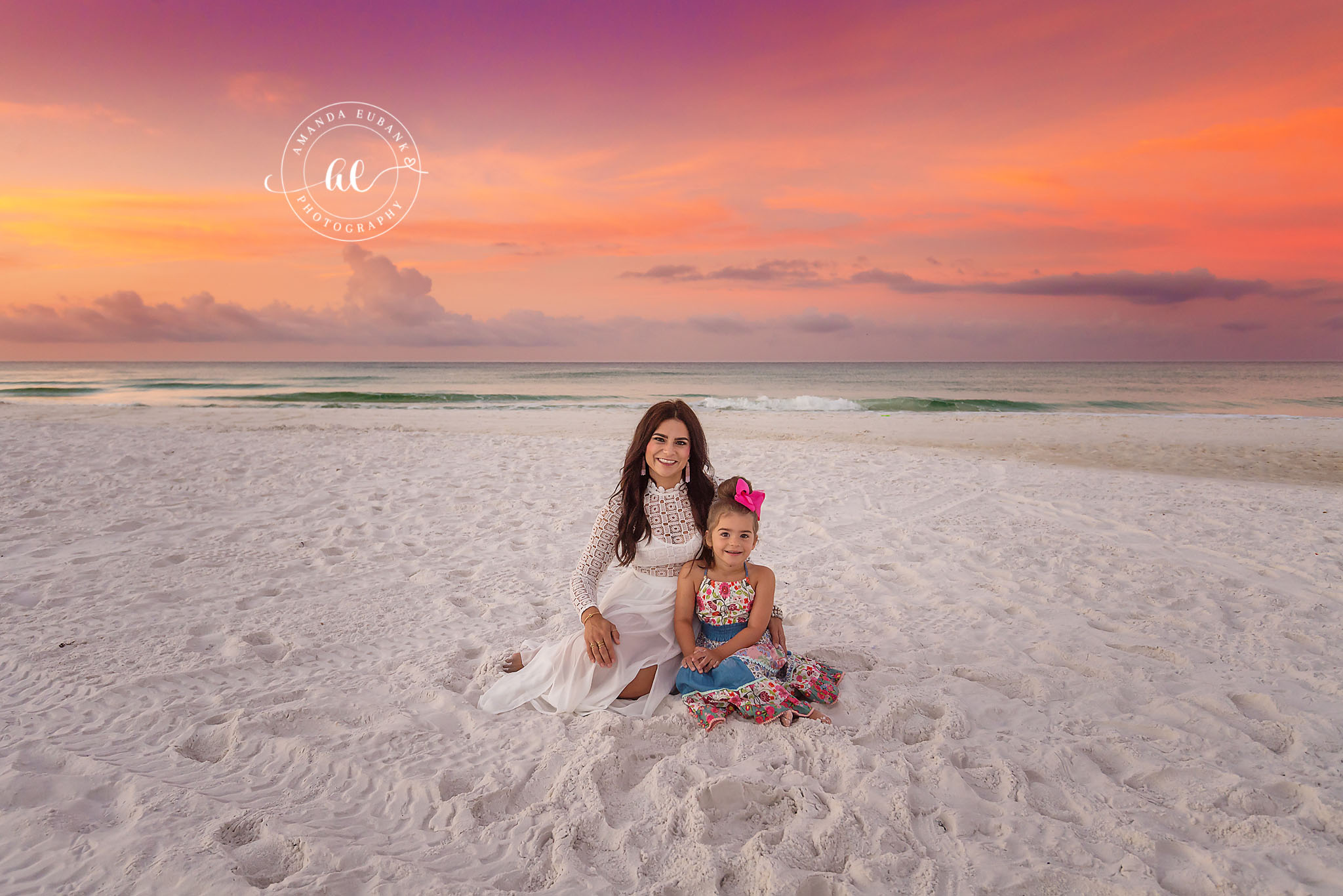 Mother and Daughter on White Sand | Family Photographer in Tampa, Florida Family beach portraits in Tampa, FL showing a mother and daughter sitting together on white sand in soft pastel light.