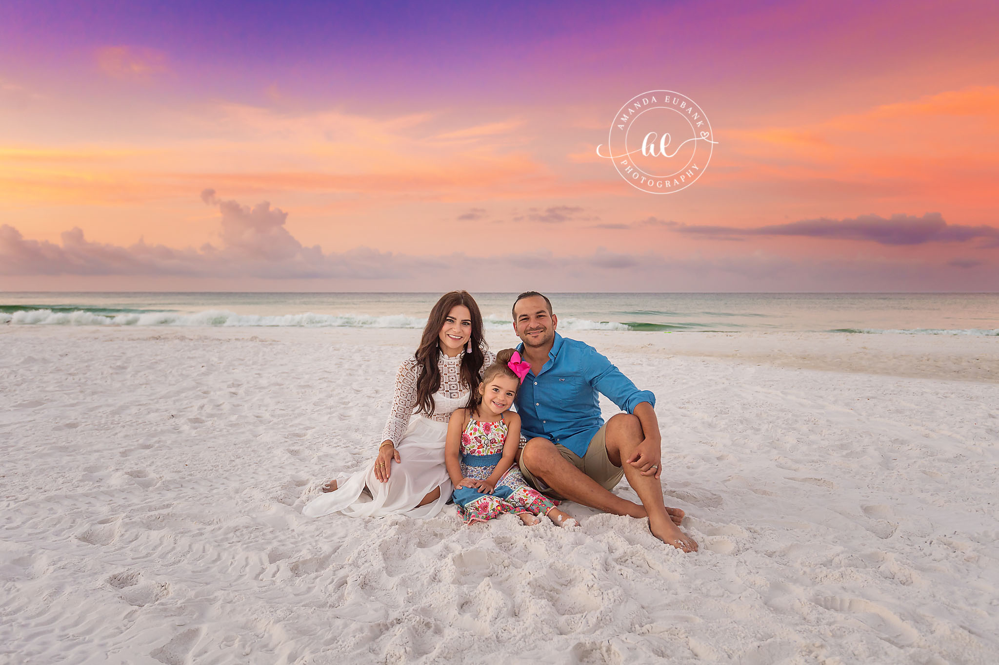 Family of Four at Dusk — Tampa Bay Family Portraits A family of four sitting on the sand as the last pastel light fades — beach family photography in Tampa Bay.