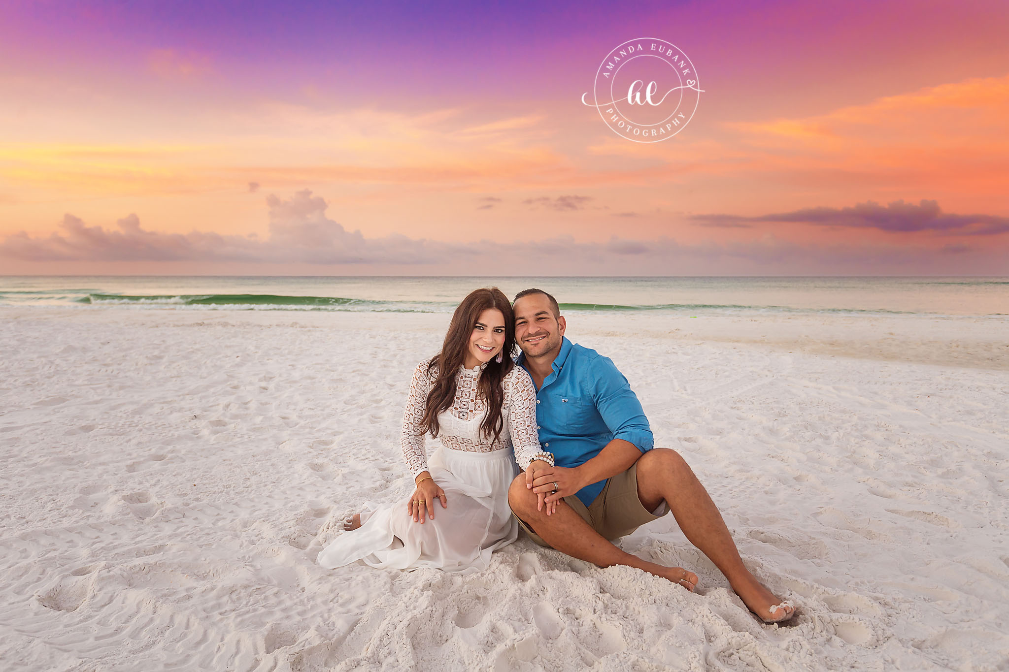 Parents on the Sand | Tampa Couples Photographer A couple sitting close together on the sand under a lavender evening sky during a Tampa couples photography session.