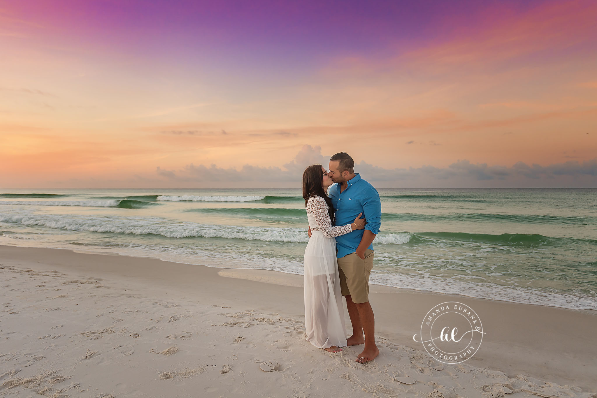 Kiss at the Shoreline — Tampa Bay Couples Portraits A couple kissing at the shoreline as the emerald surf slides past at dusk — beach couples photography in Tampa Bay.