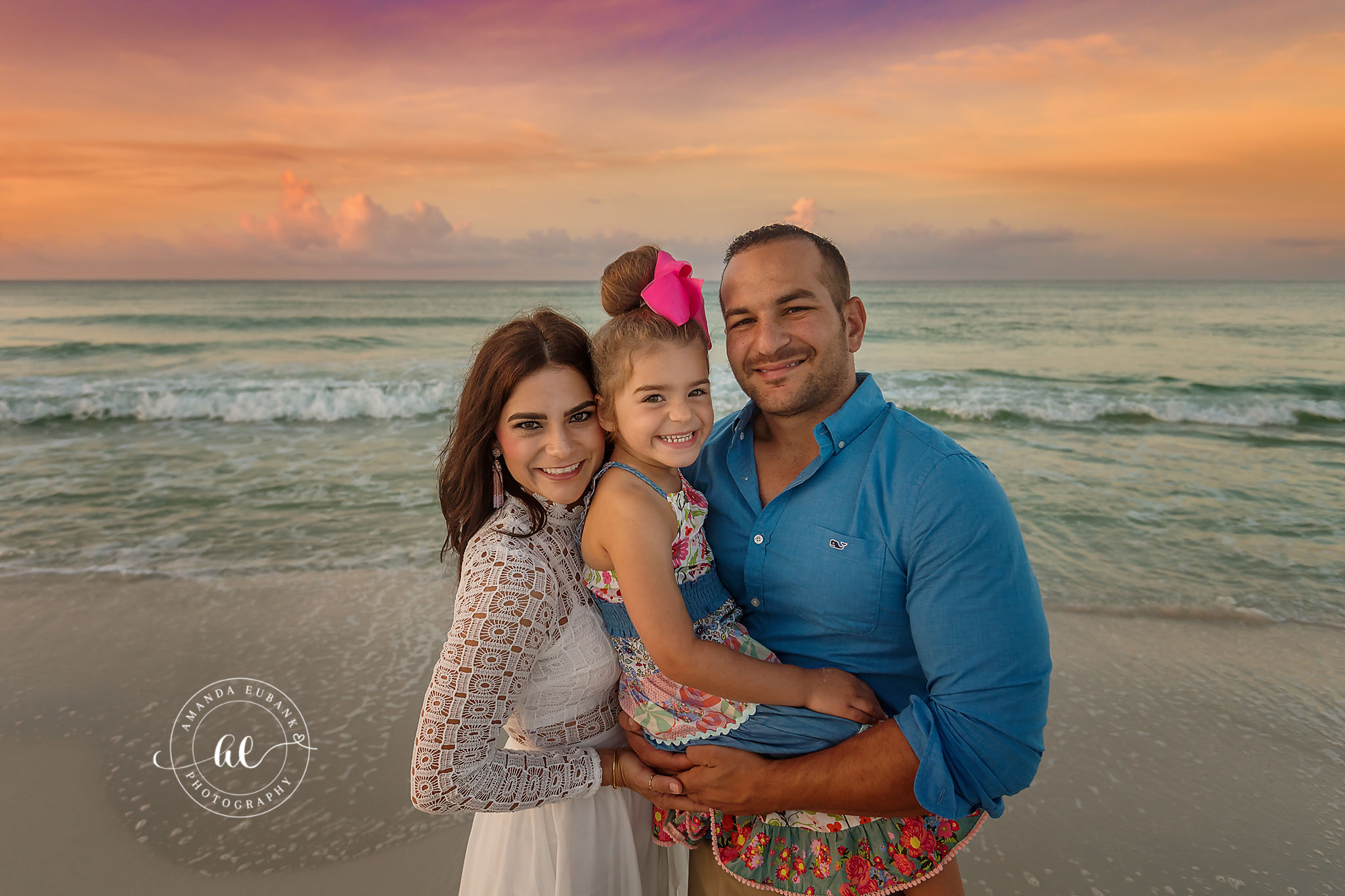 Close Family Portrait | Tampa Beach Family Photography Tampa family photographer captures a close portrait of a mom, dad and daughter with the emerald Gulf behind them.