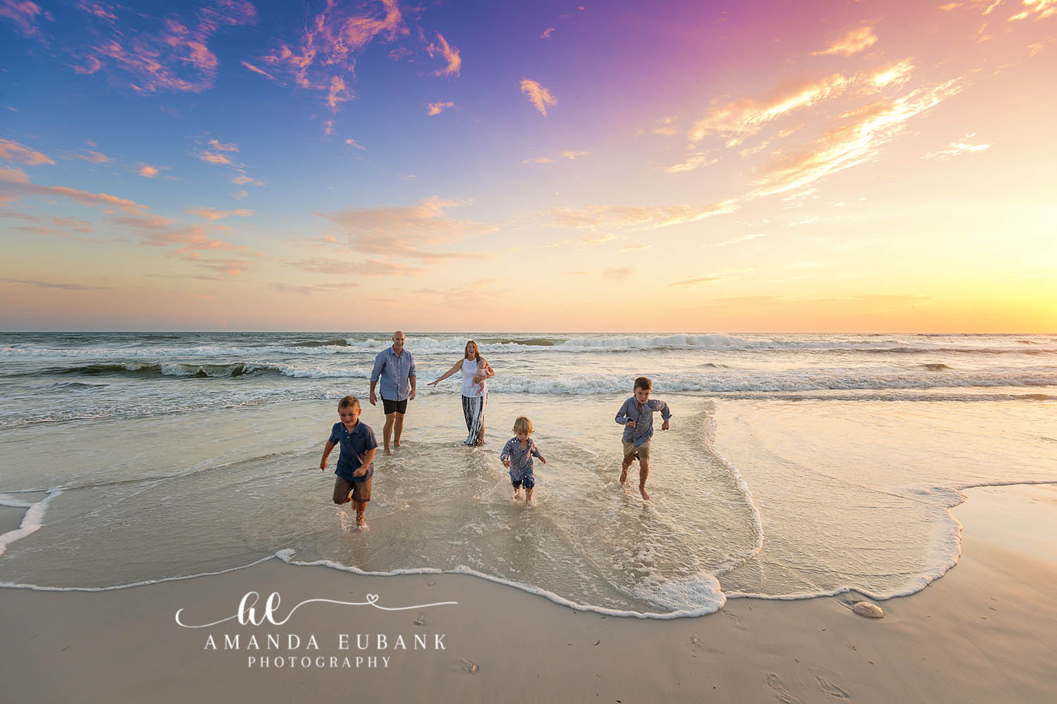 Boys Running in the Surf | Tampa Children’s Photographer Three boys running through the shallow surf toward their dad at sunset during a children’s portrait session in Tampa, Florida.
