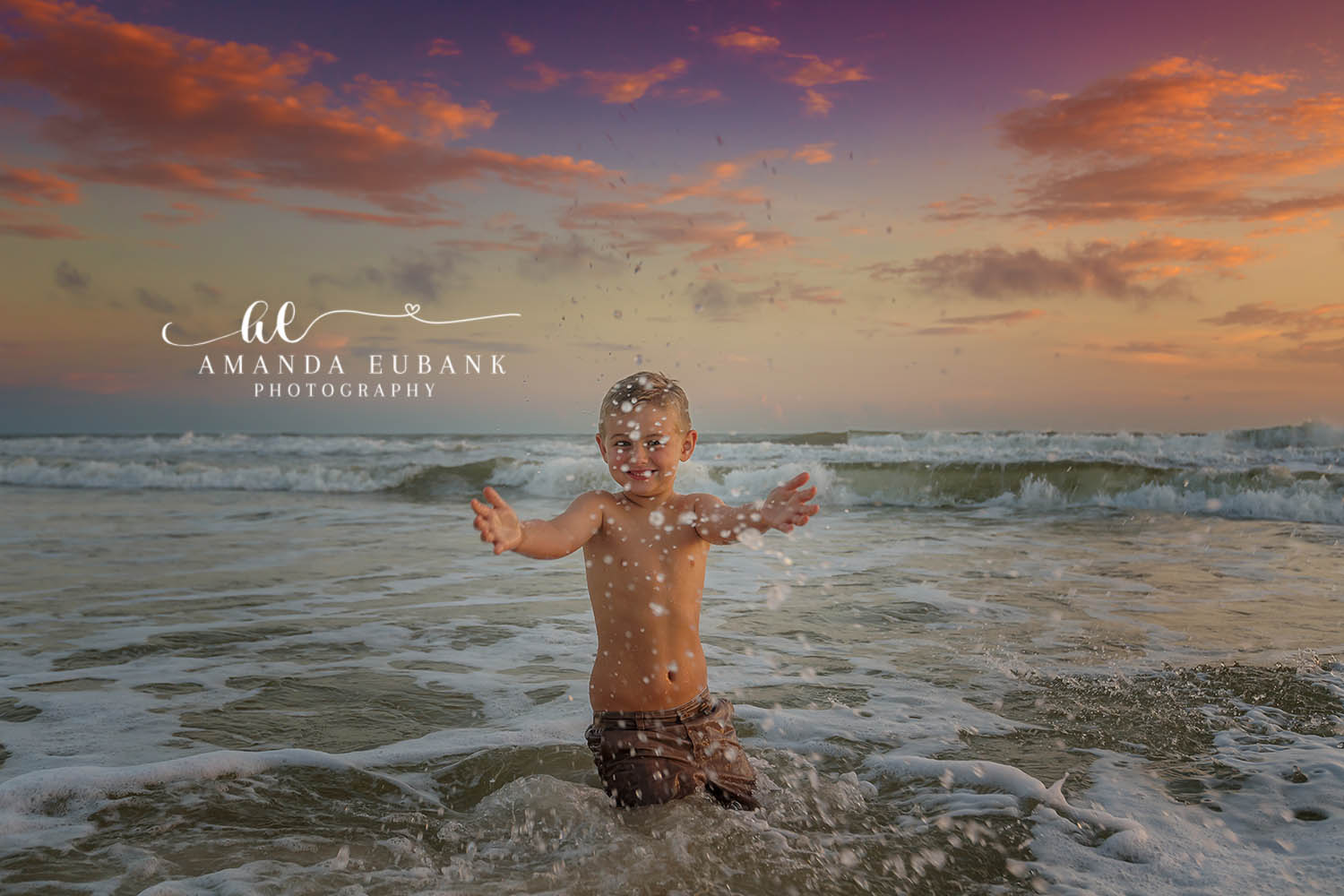 Cake Smash in the Surf | Beach Milestone Photos in Tampa, FL Tampa baby photographer captures a baby covered in frosting standing in the surf with arms out at sunset.