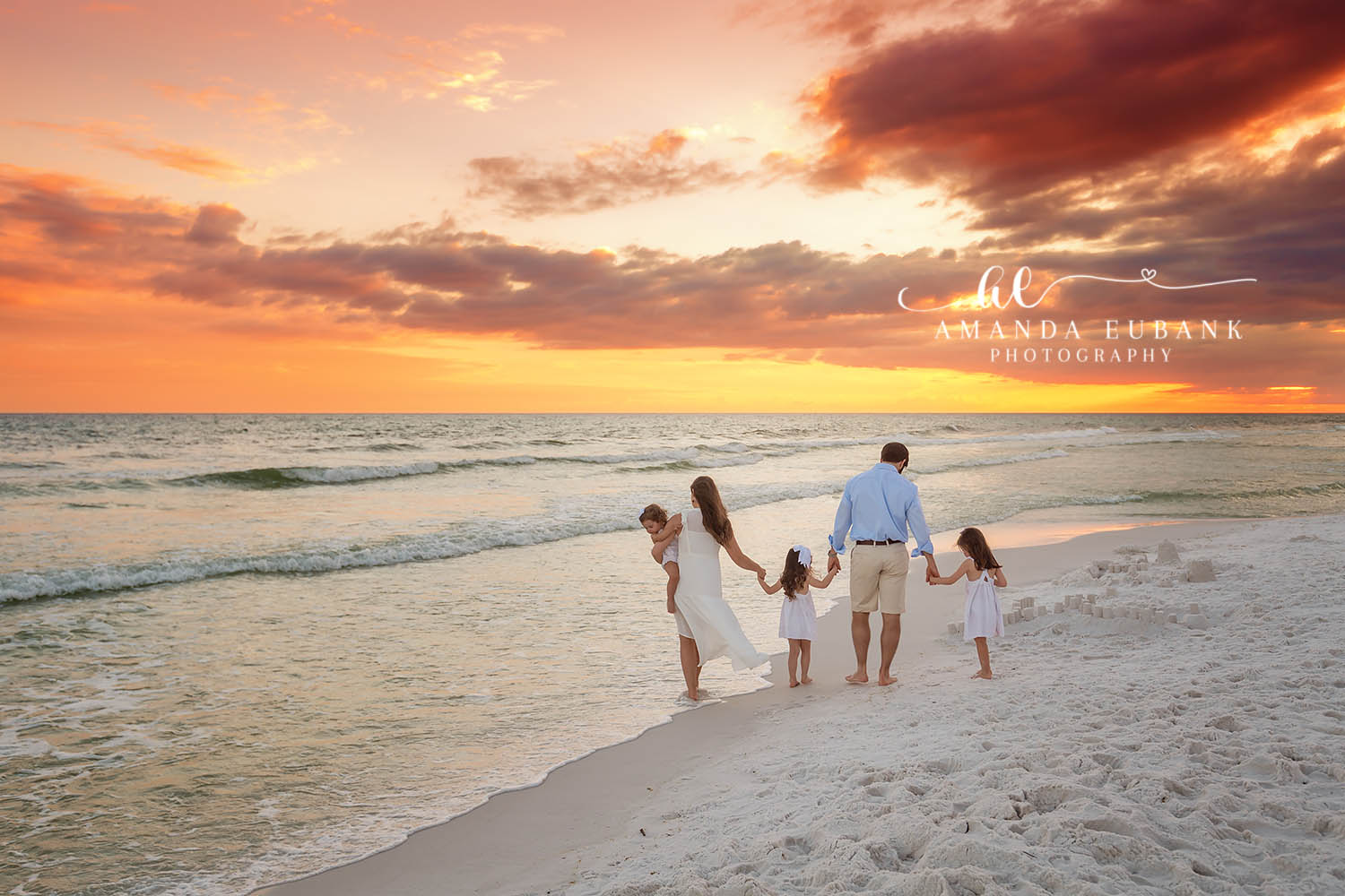 Family Walk on Wet Sand | Tampa Beach Family Photography Tampa family photographer captures a family of six walking across wet sand as the sun bursts along the horizon.