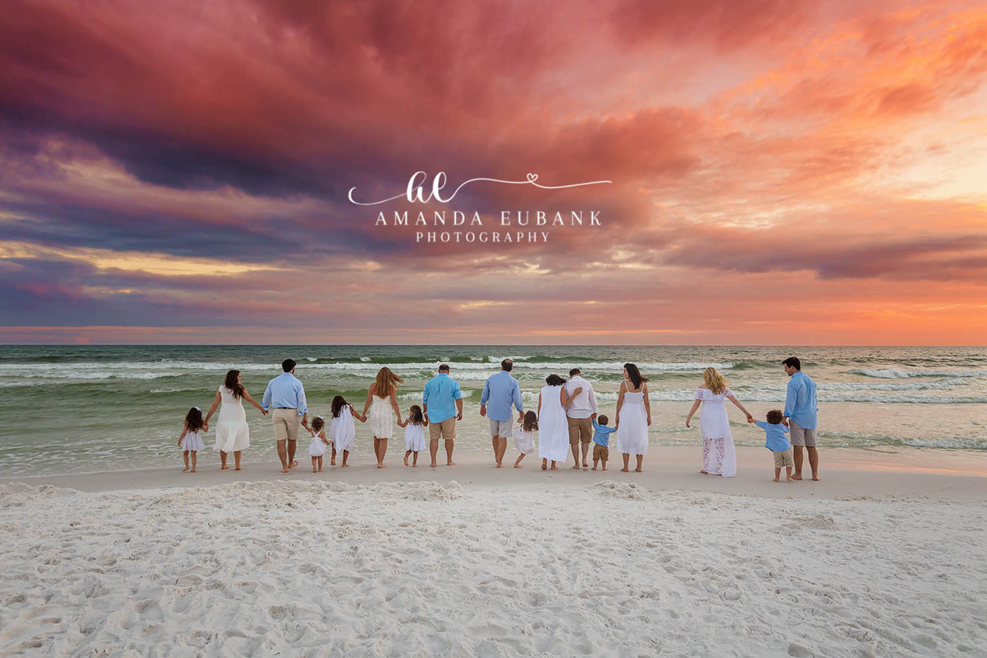 Extended Family Facing the Sunset | Large Family Beach Photos in Tampa, FL Tampa extended family photographer captures an extended family of fourteen standing together facing the sunset.