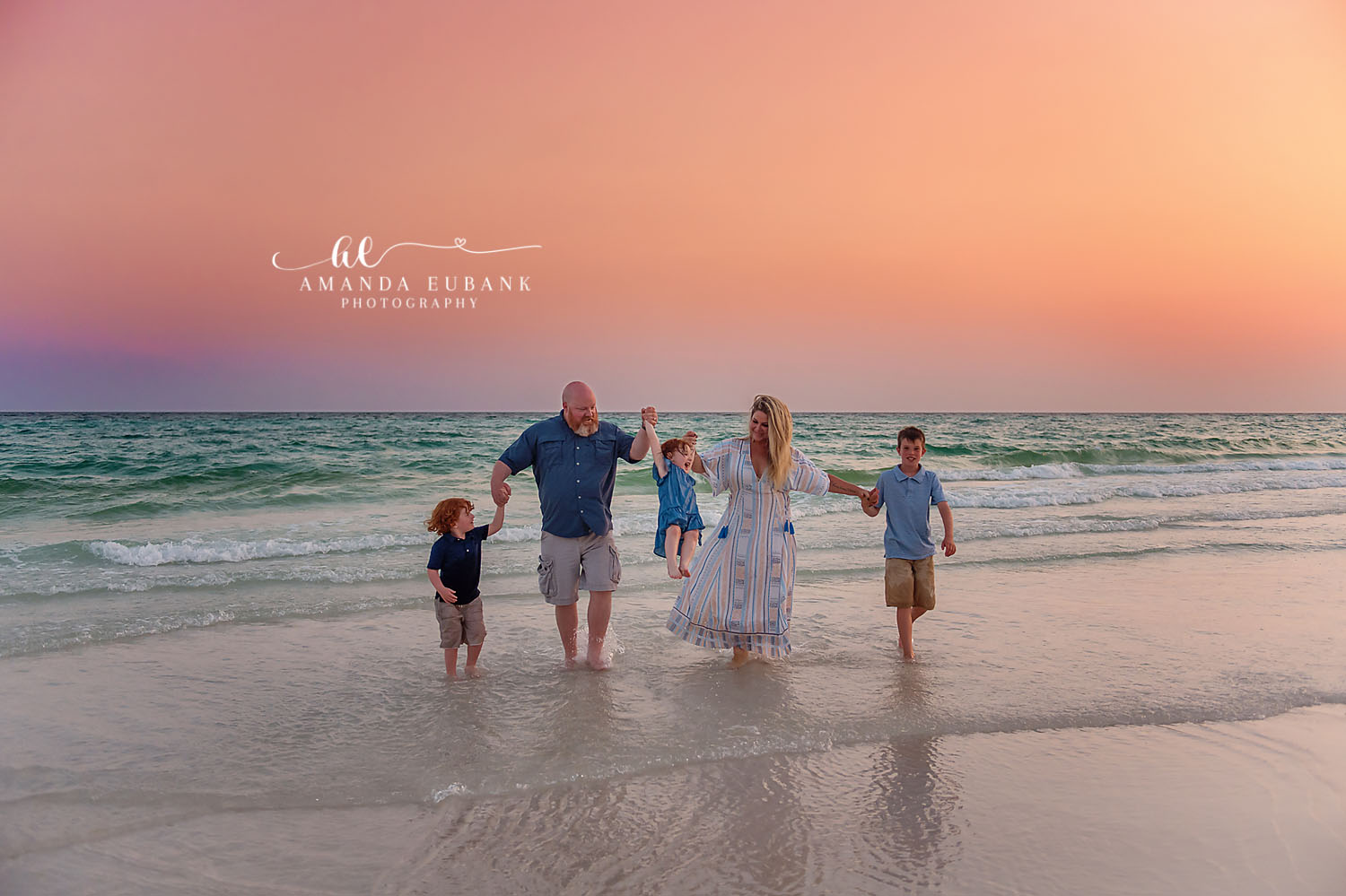 Family Walking in the Shallows — Tampa Bay Family Portraits A family of five walking through the shallows on mirror-wet sand — beach family photography in Tampa Bay.