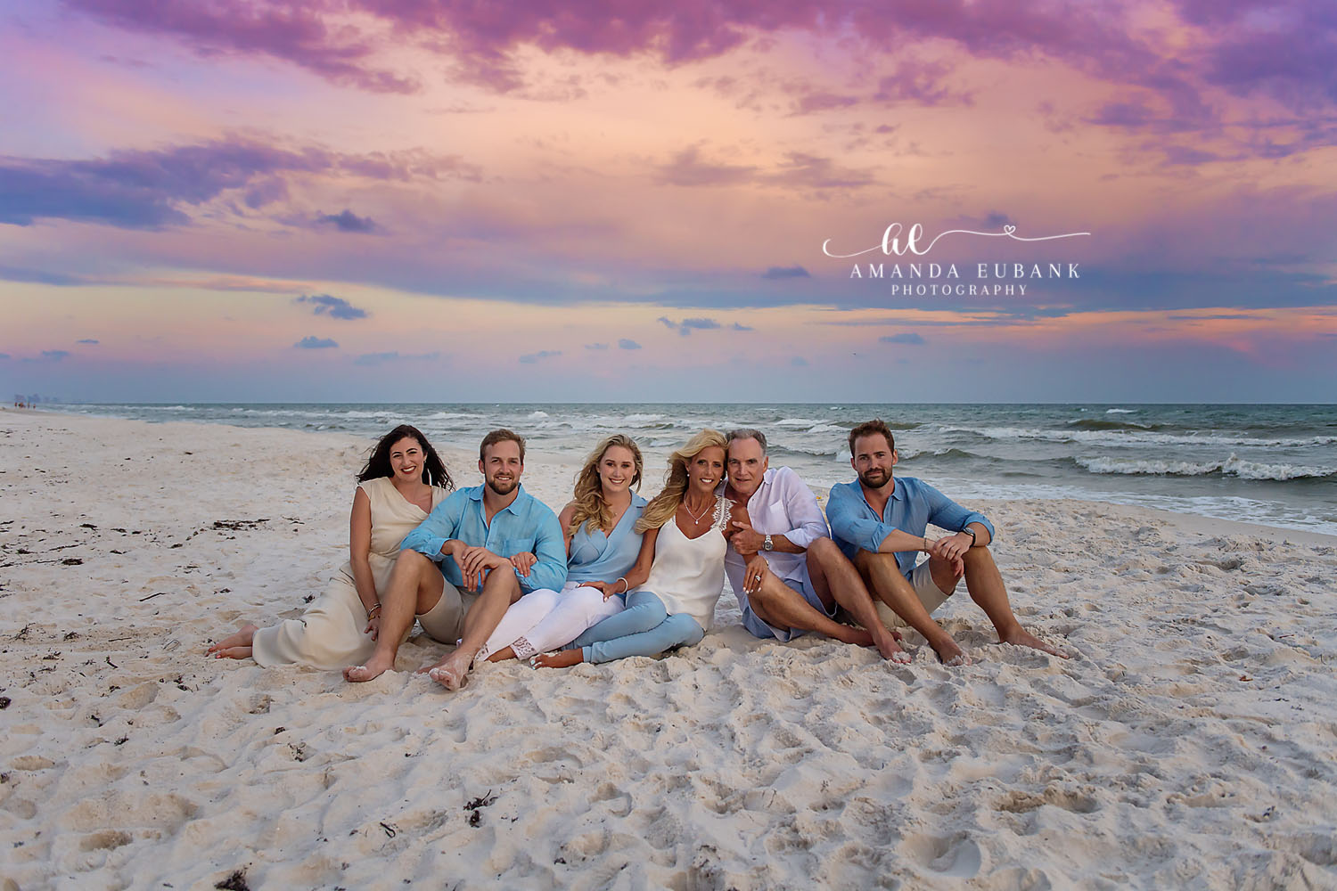 Family Seated on the Sand | Tampa Family Photographer A family of six sitting on the sand in light blue and cream at dusk during a Tampa family photography session.