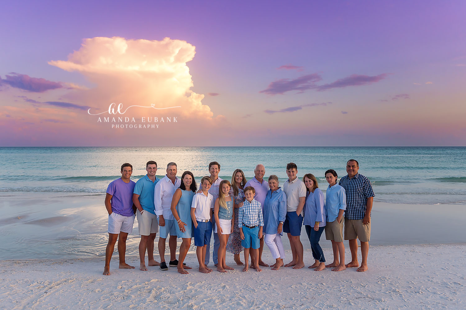 Big Family Beach Portrait — Tampa Bay Extended Family Session An extended family of fifteen on the beach beneath a towering thunderhead at a large family beach session in Tampa, FL.