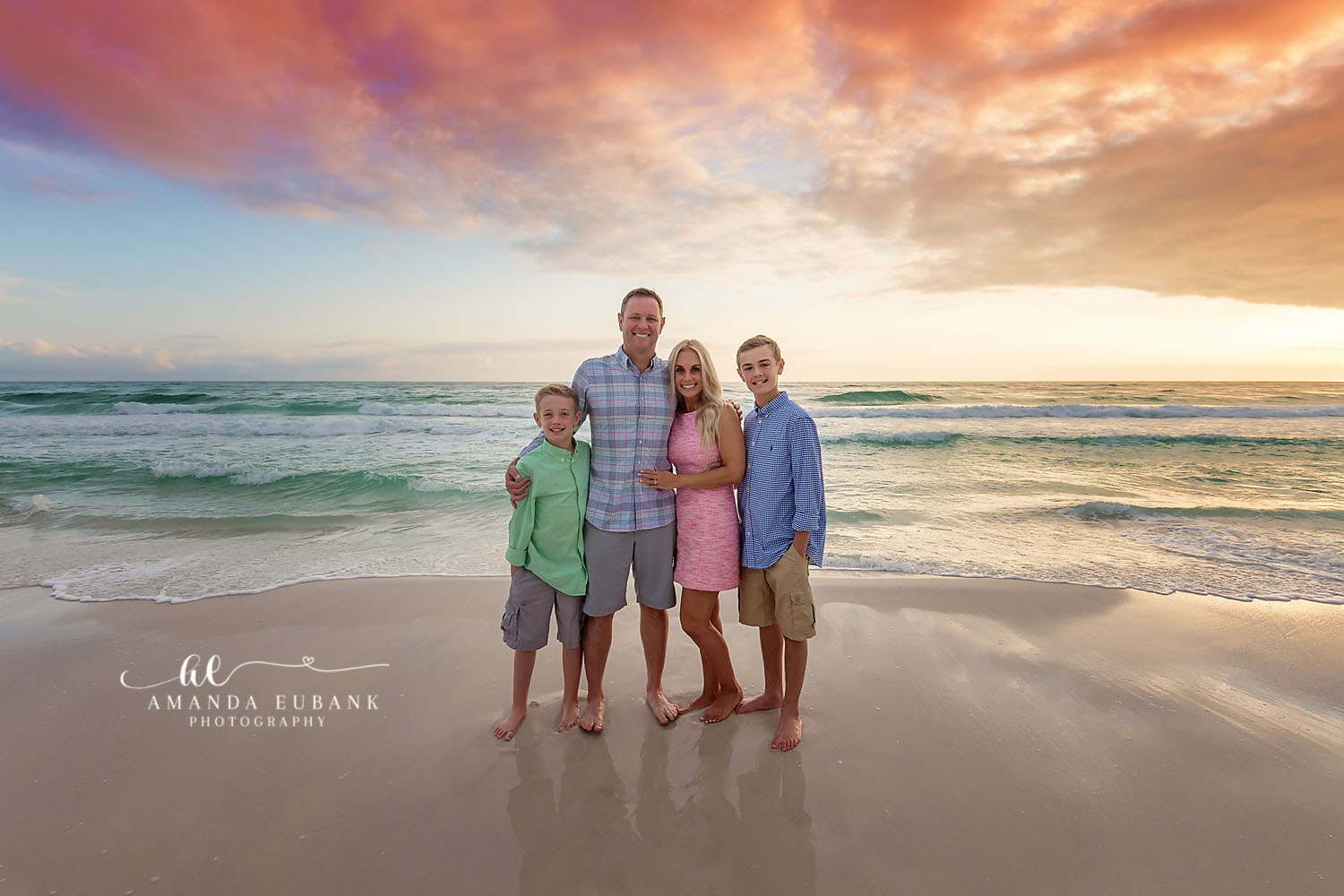 Family of Six at Sunset | Tampa Beach Family Photography Tampa family photographer captures a family of six standing on the beach in green, pink and blue at sunset.