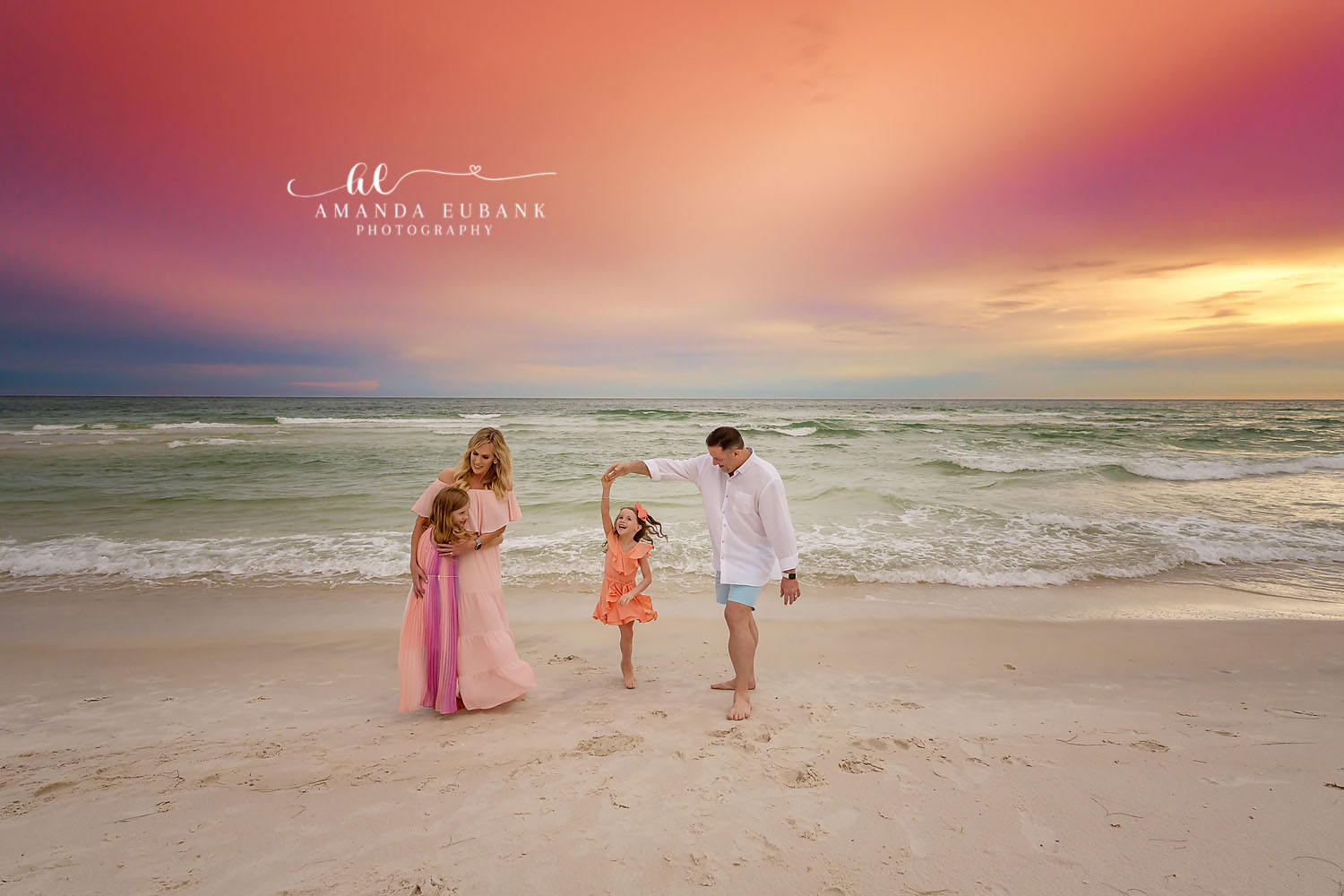 Dad Twirling His Daughter | Tampa Beach Family Photography Tampa family photographer captures a dad twirling his daughter while mom watches under a pastel sunset.