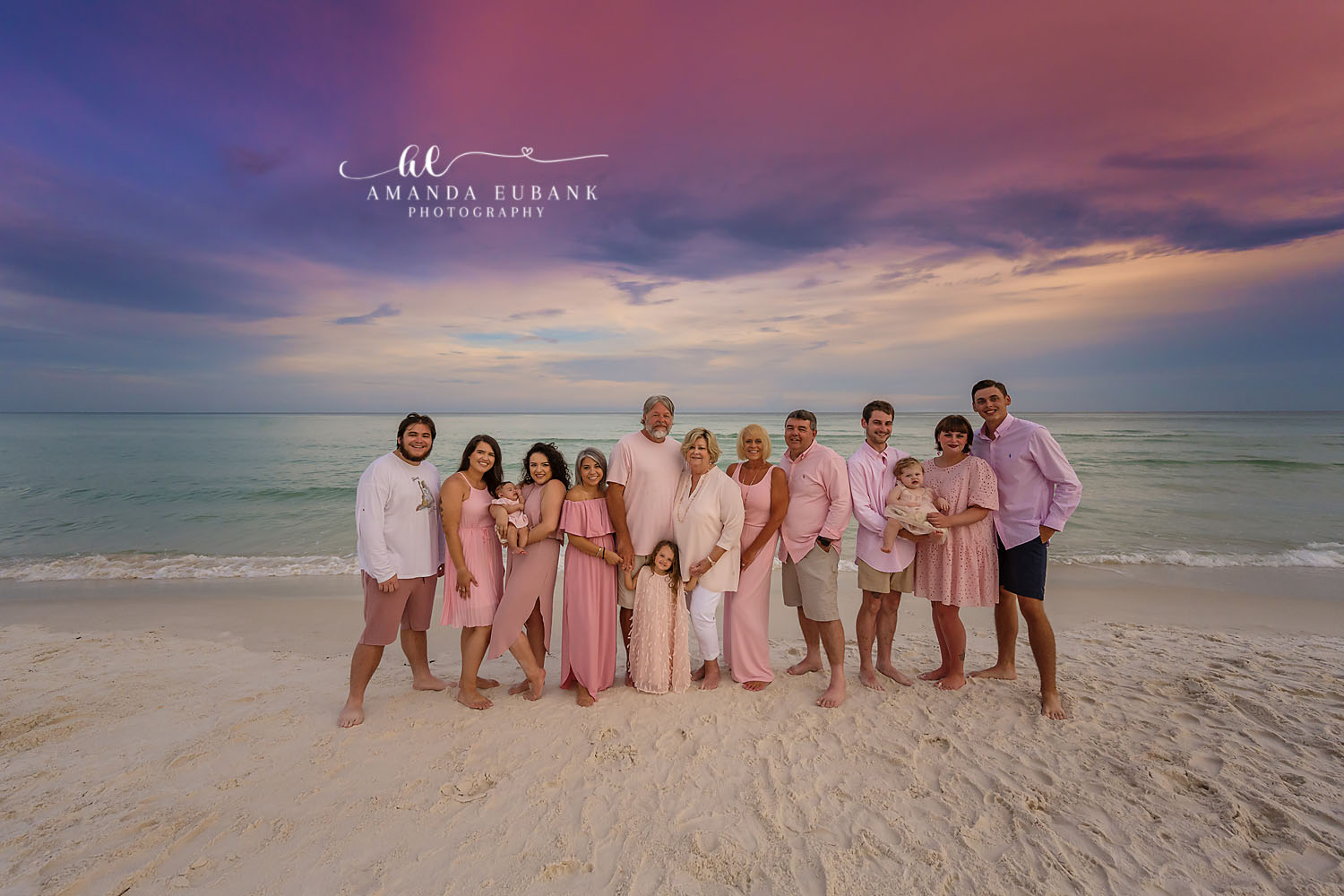 Extended Family in Blush — Tampa Bay Extended Family Session A large extended family in blush and pink on the beach under purple clouds at a large family beach session in Tampa, FL.