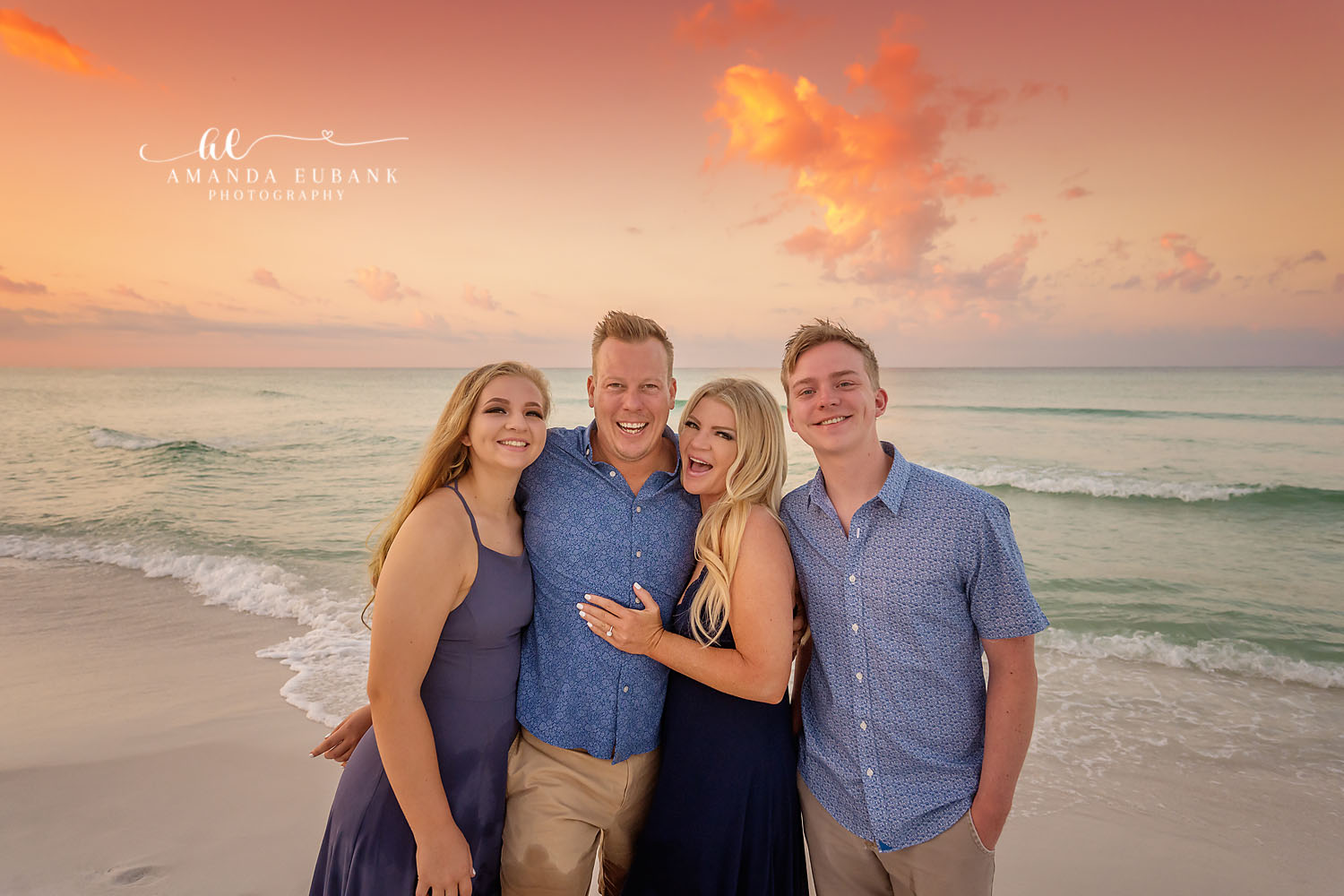 Close Family of Four — Tampa Bay Family Portraits A close portrait of a family of four with the turquoise Gulf behind them — beach family photography in Tampa Bay.