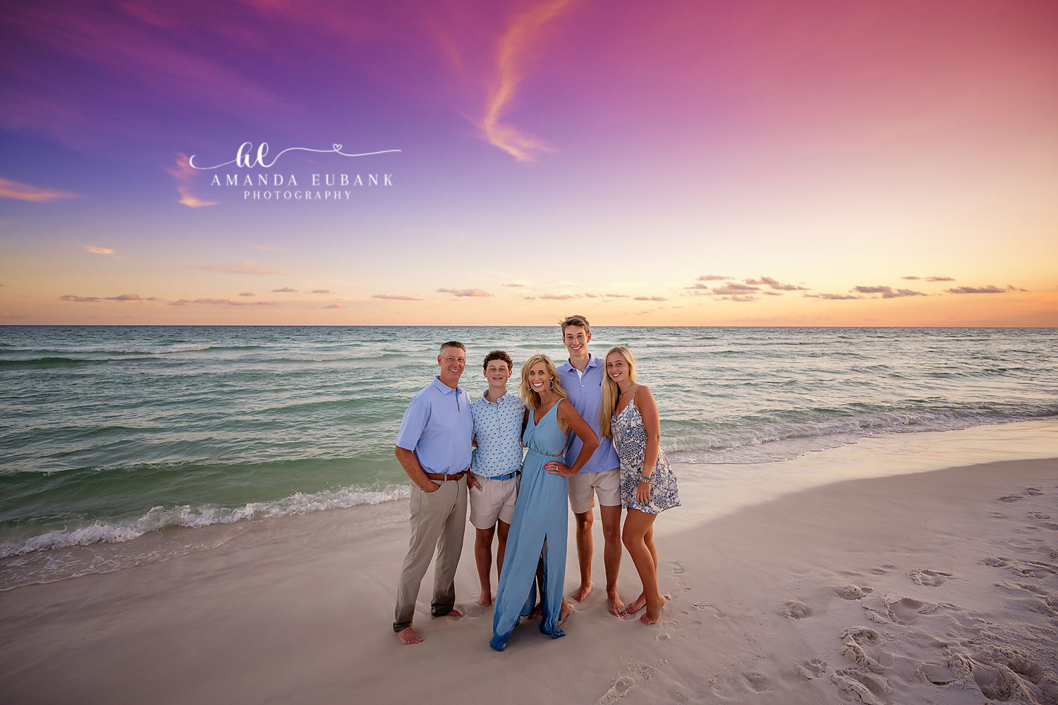 Family of Six on the Shoreline | Tampa Family Photographer A family of six on the shoreline in blue and white under a purple sky during a Tampa family photography session.
