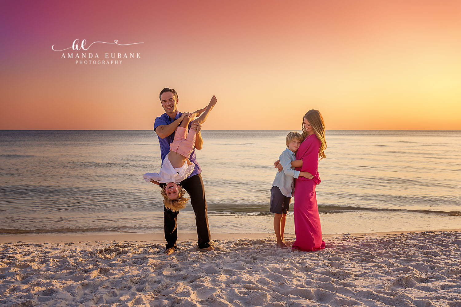 Upside Down Laughter | Family Photographer in Tampa, Florida Family beach portraits in Tampa, FL showing a dad holding a child upside down as the family laughs in golden light.