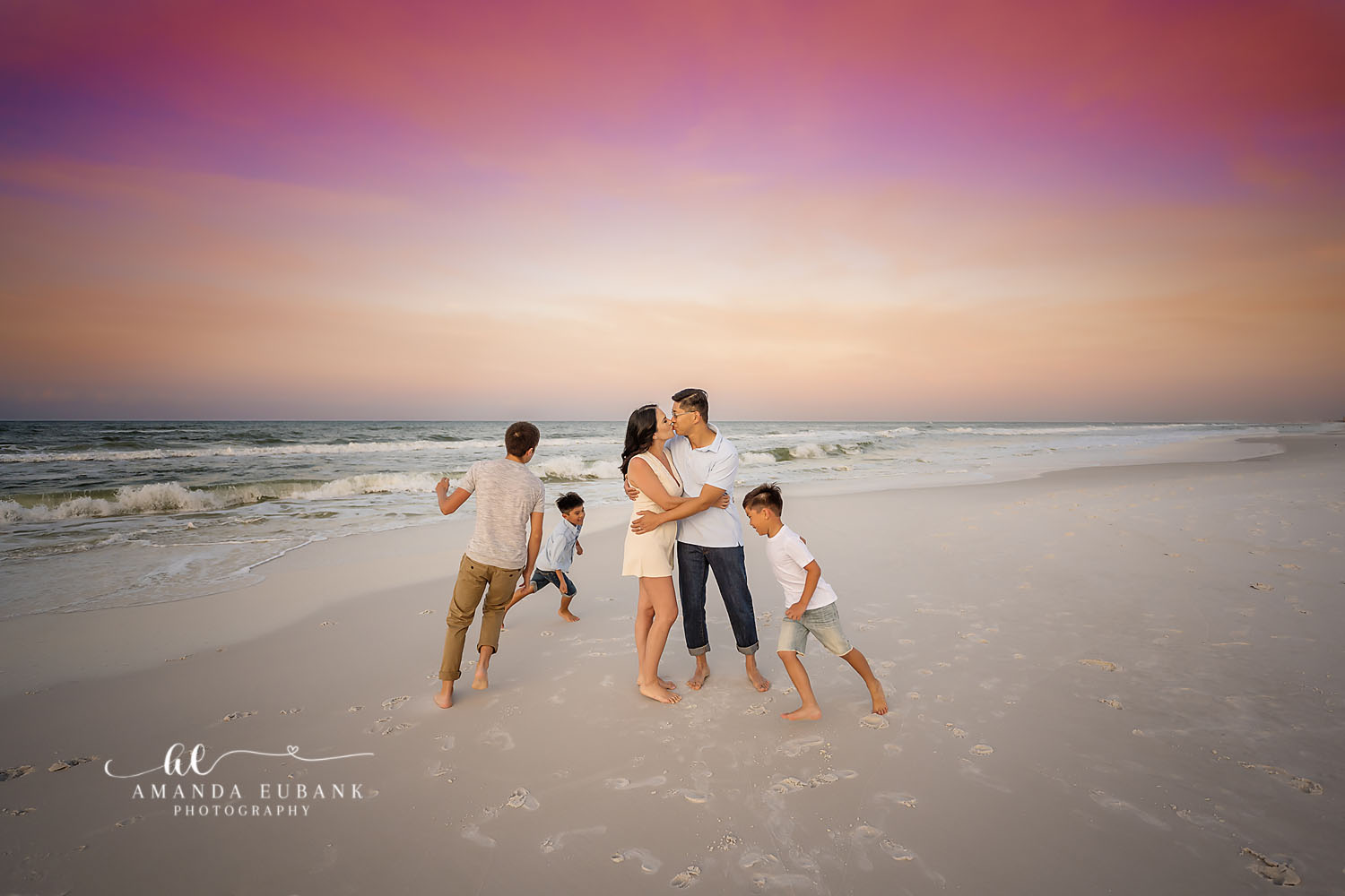 Family Running on the Beach | Family Photographer in Tampa, Florida Family beach portraits in Tampa, FL showing a family of five running and playing on the beach in neutral tones.