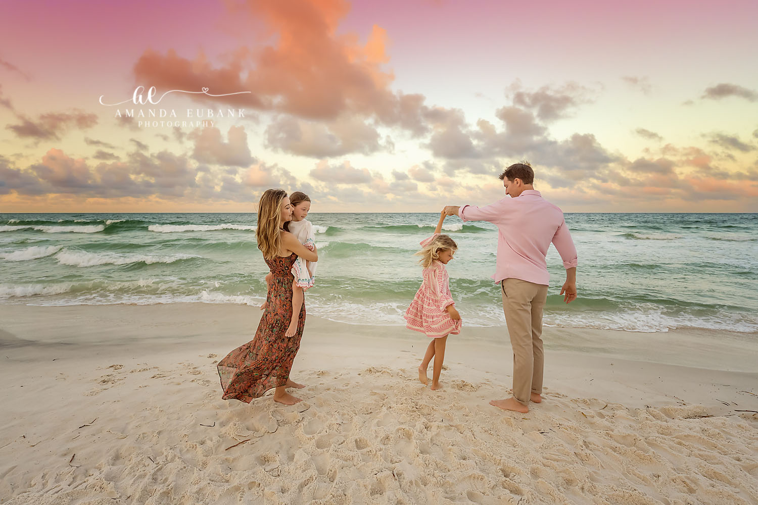 Swinging Their Daughter — Tampa, FL Family Session Parents swinging their daughter between them at the water's edge at a beach family session near Tampa, Florida.
