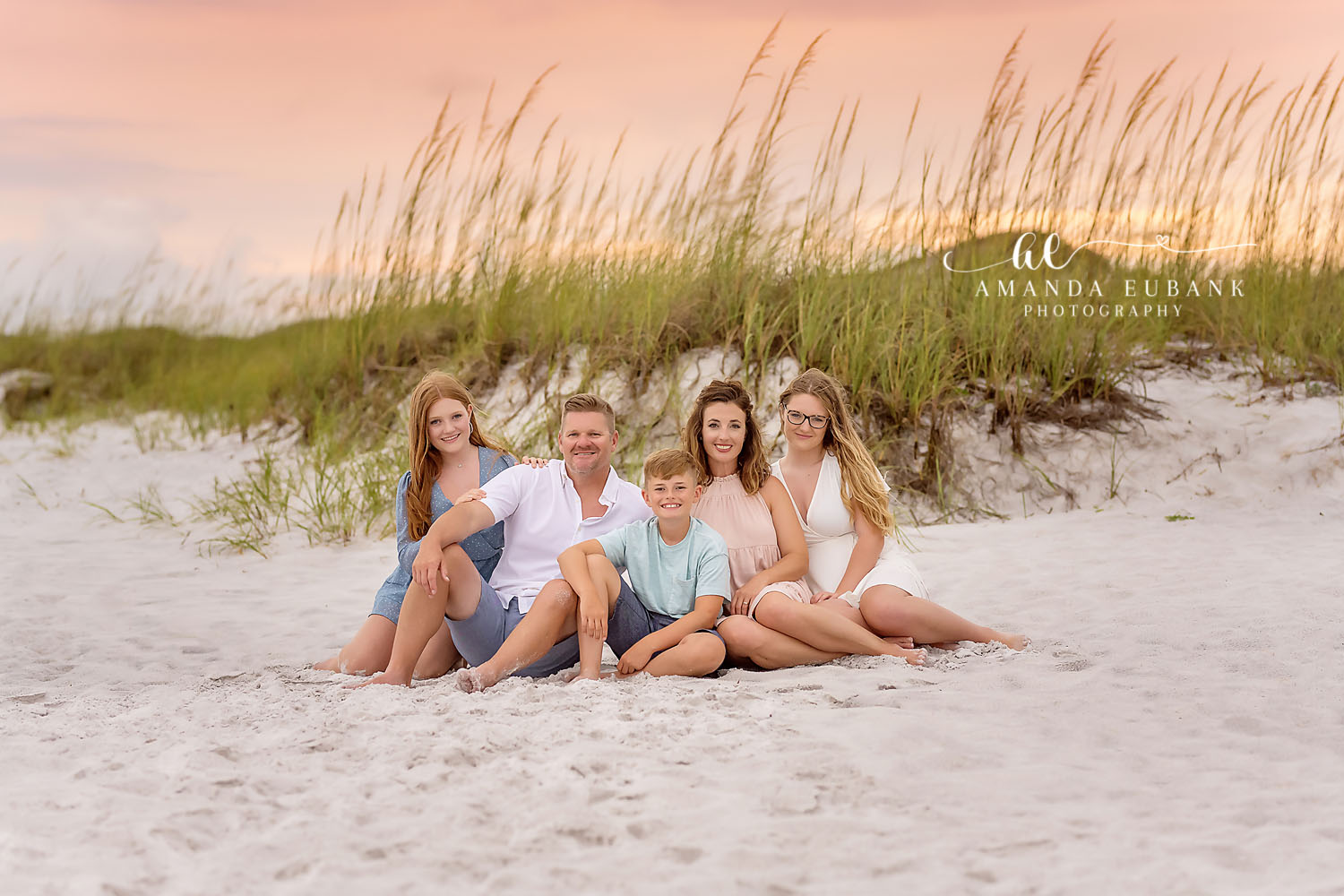 Family in the Sea Oats — Tampa Bay Family Portraits A family of five sitting on a dune among the sea oats in warm light — beach family photography in Tampa Bay.