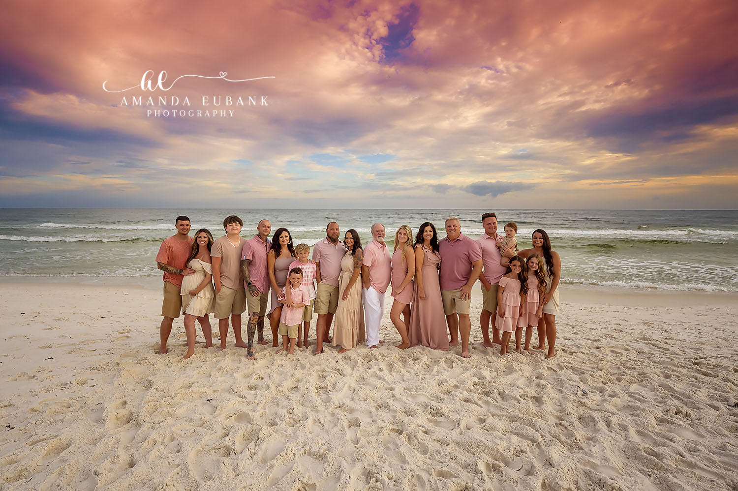 Large Family in Blush — Tampa Bay Extended Family Session An extended family of eighteen on the beach in blush and tan under purple clouds at a large family beach session in Tampa, FL.