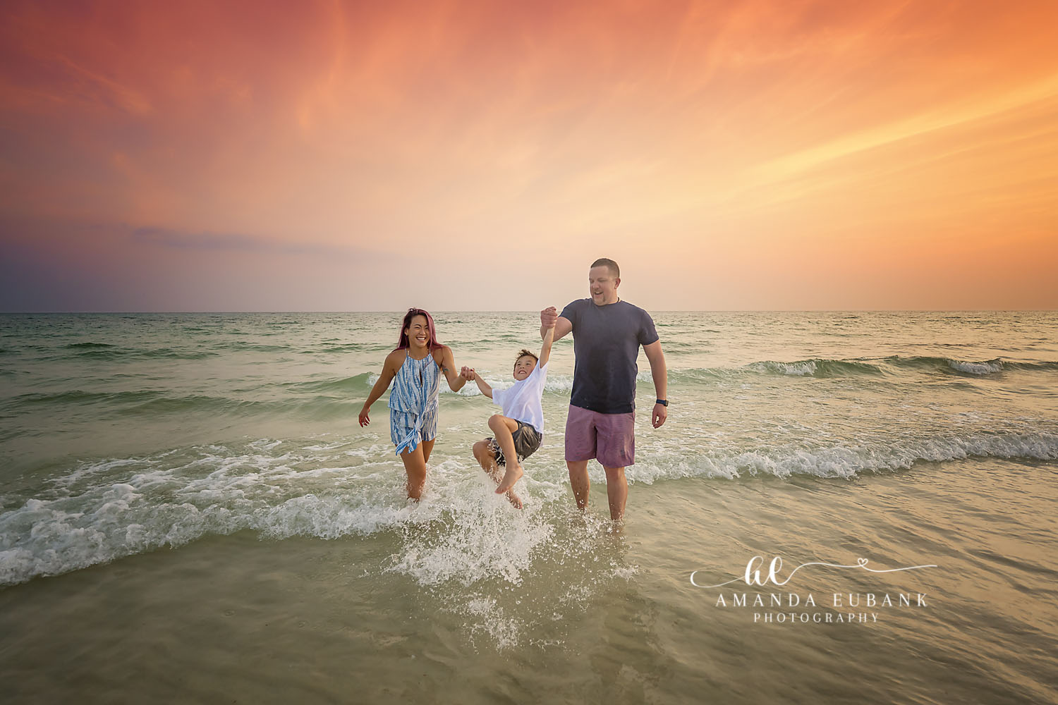 Dad and Kids Splashing — Tampa Bay Family Portraits A dad and his kids splashing through the surf in warm golden light — beach family photography in Tampa Bay.