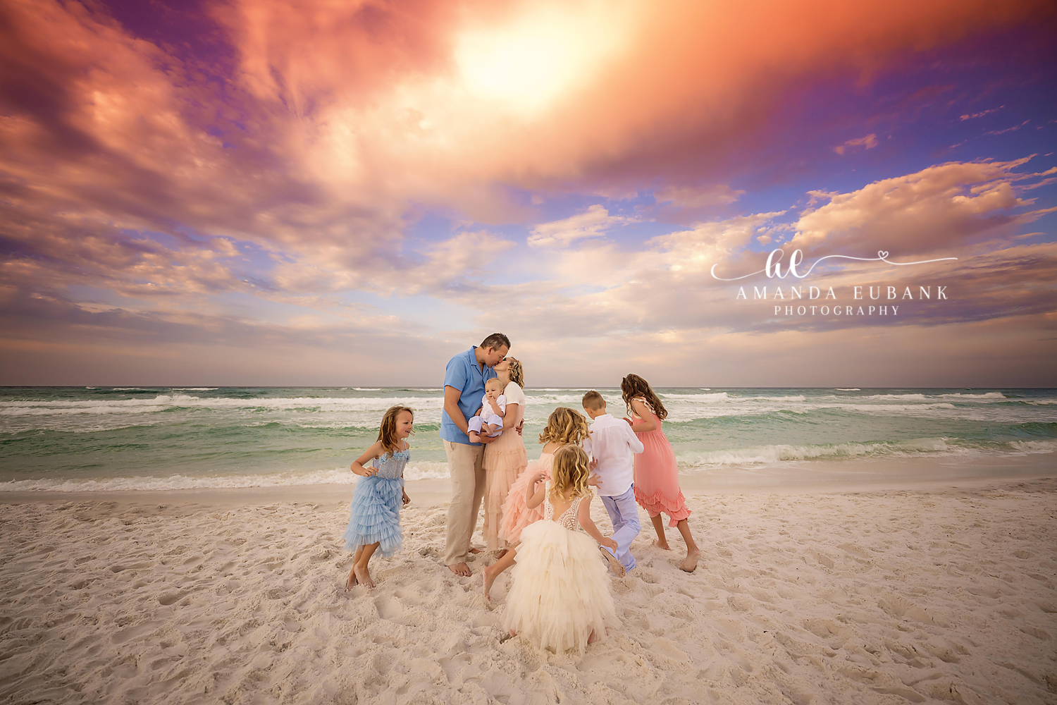 Girls in Tulle on the Sand | Tampa Family Photographer A family of five on the sand with the girls in tulle dresses under purple clouds during a Tampa family photography session.
