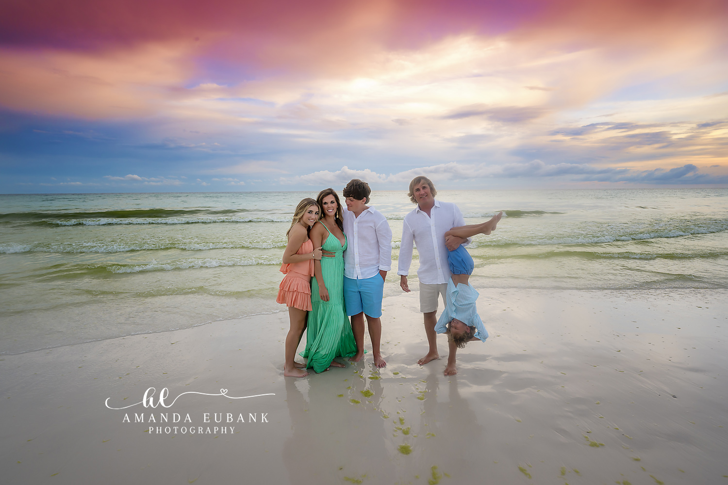 Family Watching the Sunset — Tampa Bay Family Portraits A family of five on the wet sand pointing out to sea beneath a wide dusk sky — beach family photography in Tampa Bay.