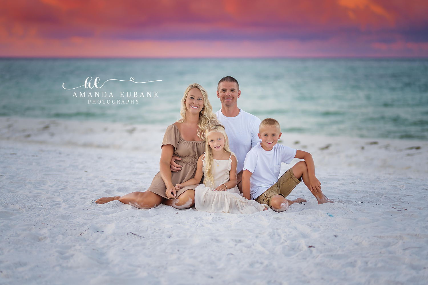 Family of Five on White Sand | Tampa Family Photographer A family of five seated on white sand in neutral tones beside the turquoise Gulf during a Tampa family photography session.